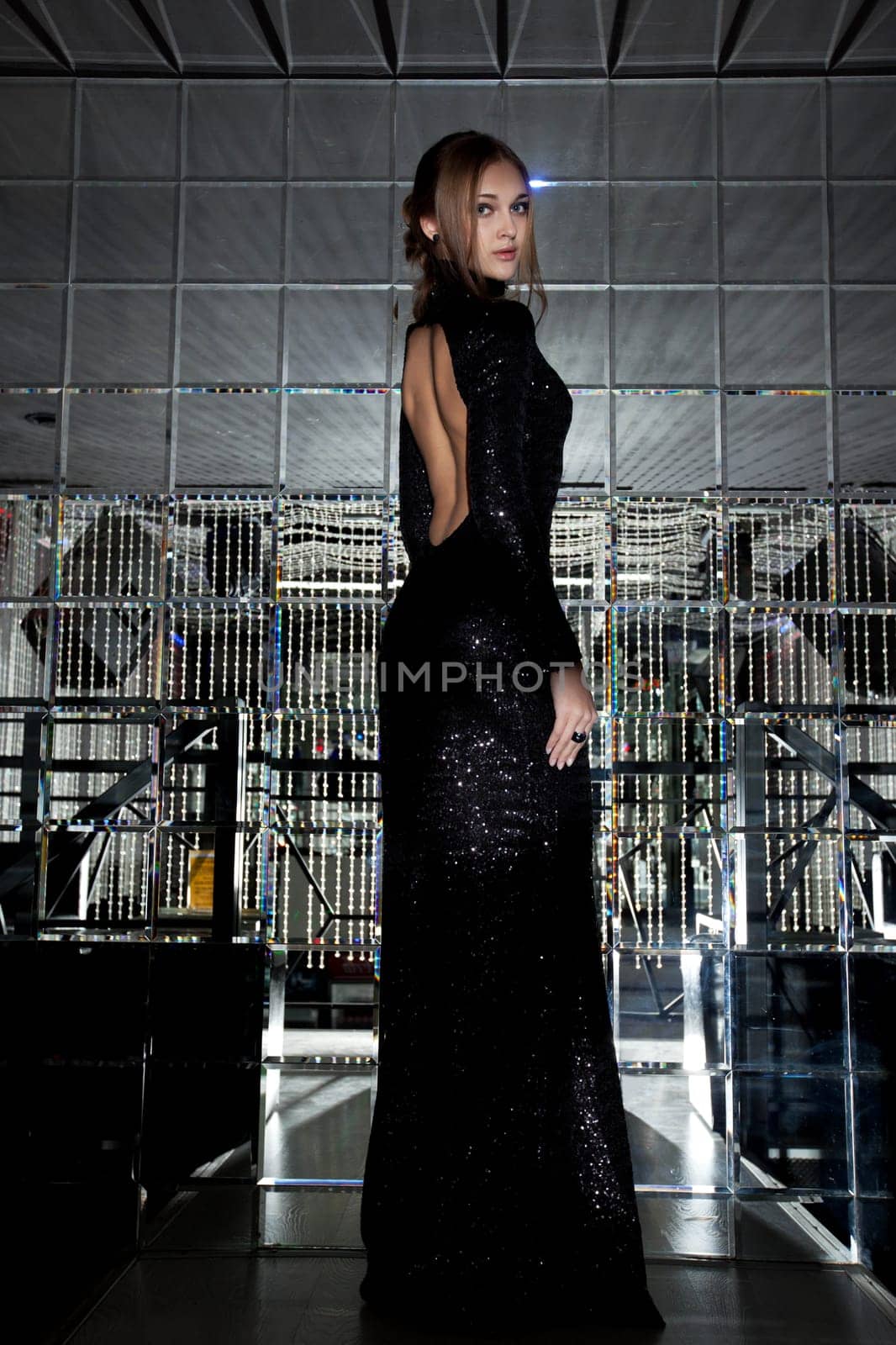Gorgeous tall girl posing in black cocktail dress