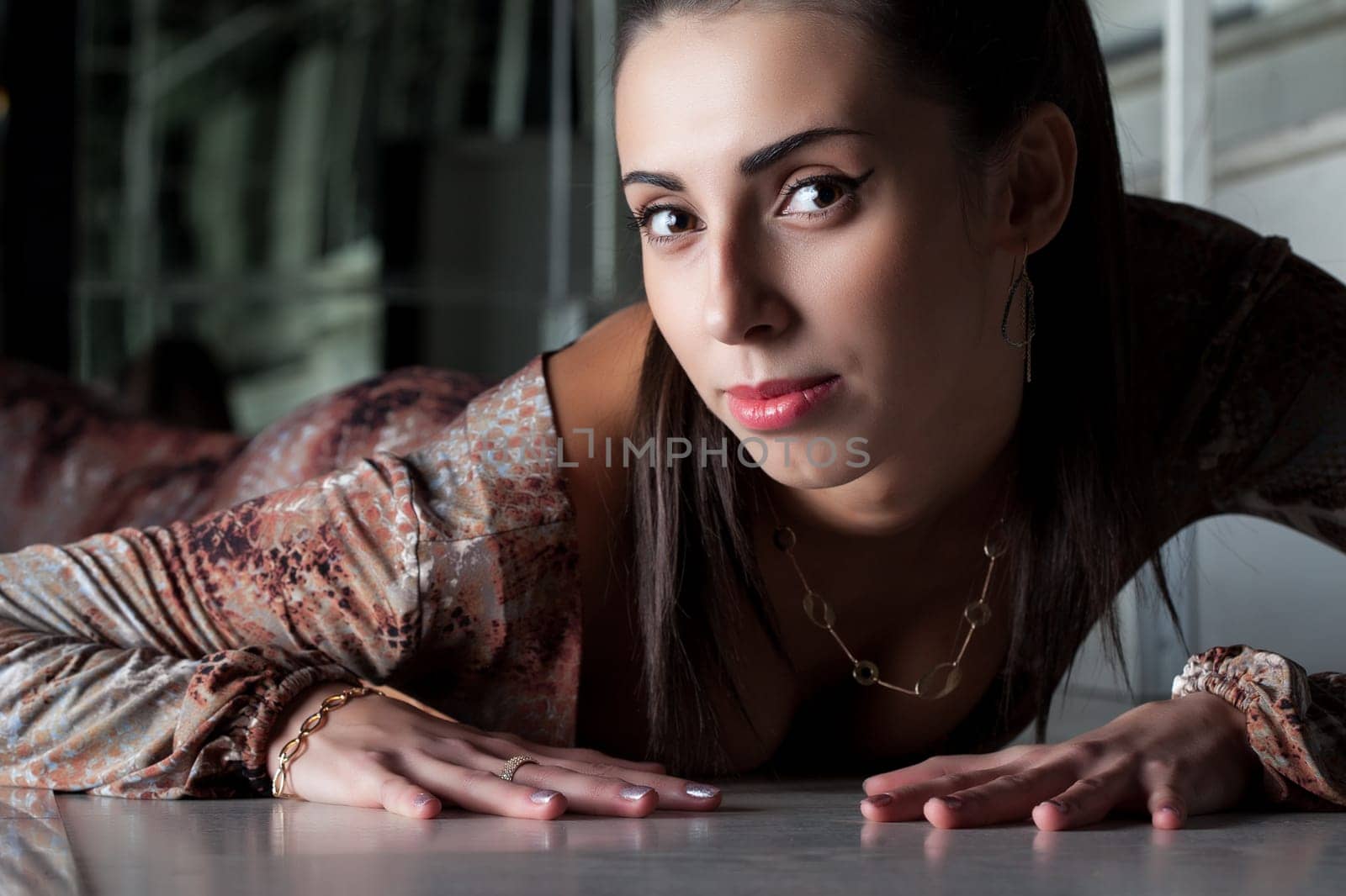 Portrait of attractive brunette in brown dress, close-up