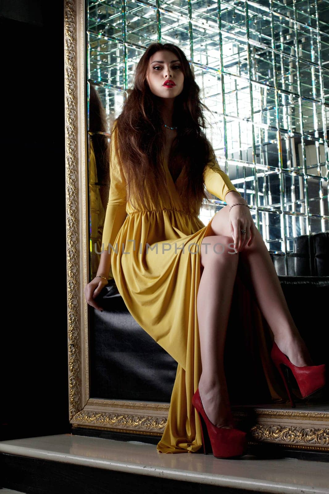 Full length portrait of Pretty young woman in yellow fashion long dress- night club