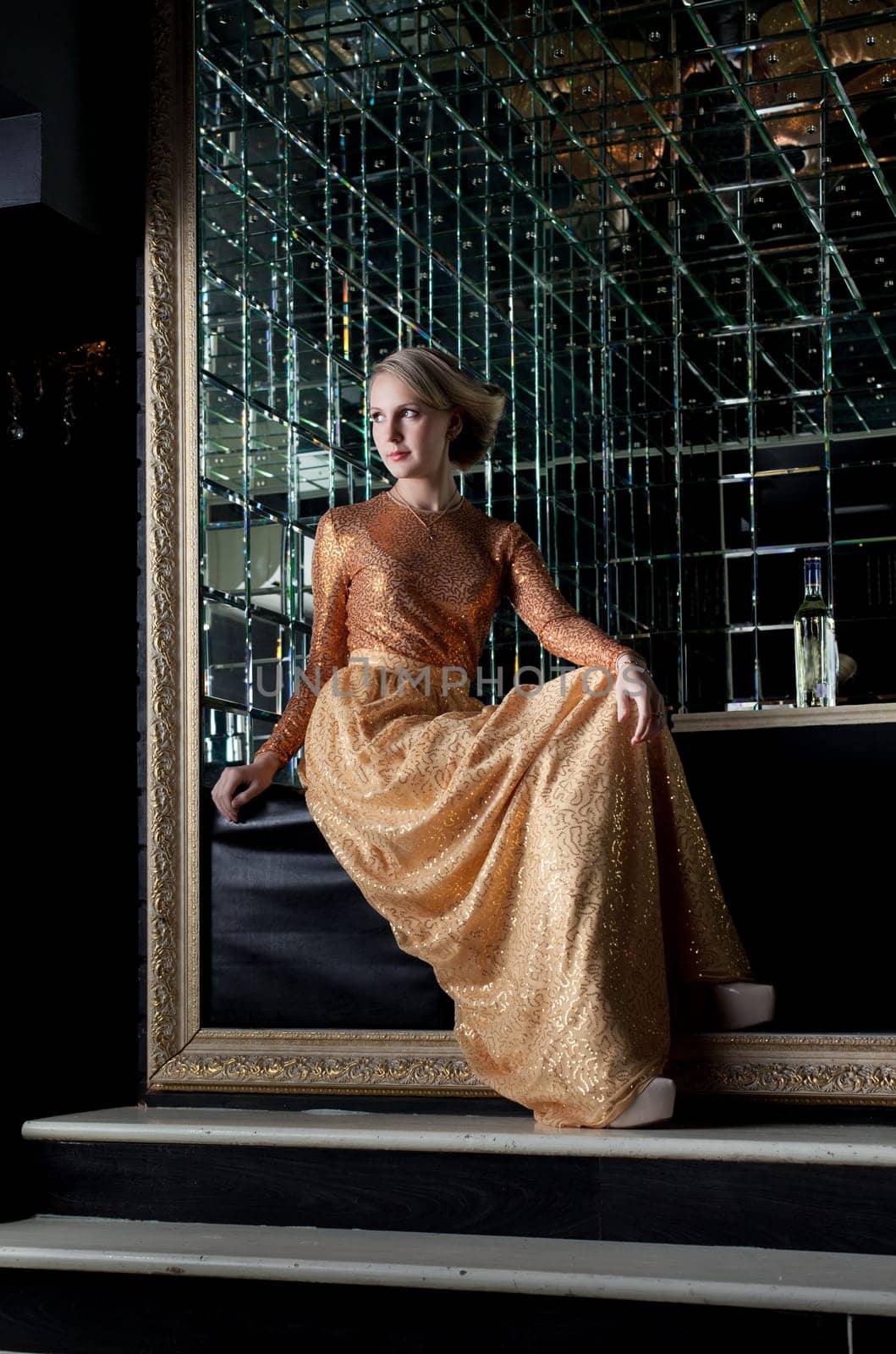 Full length portrait of woman sitting on sofa in nightclub