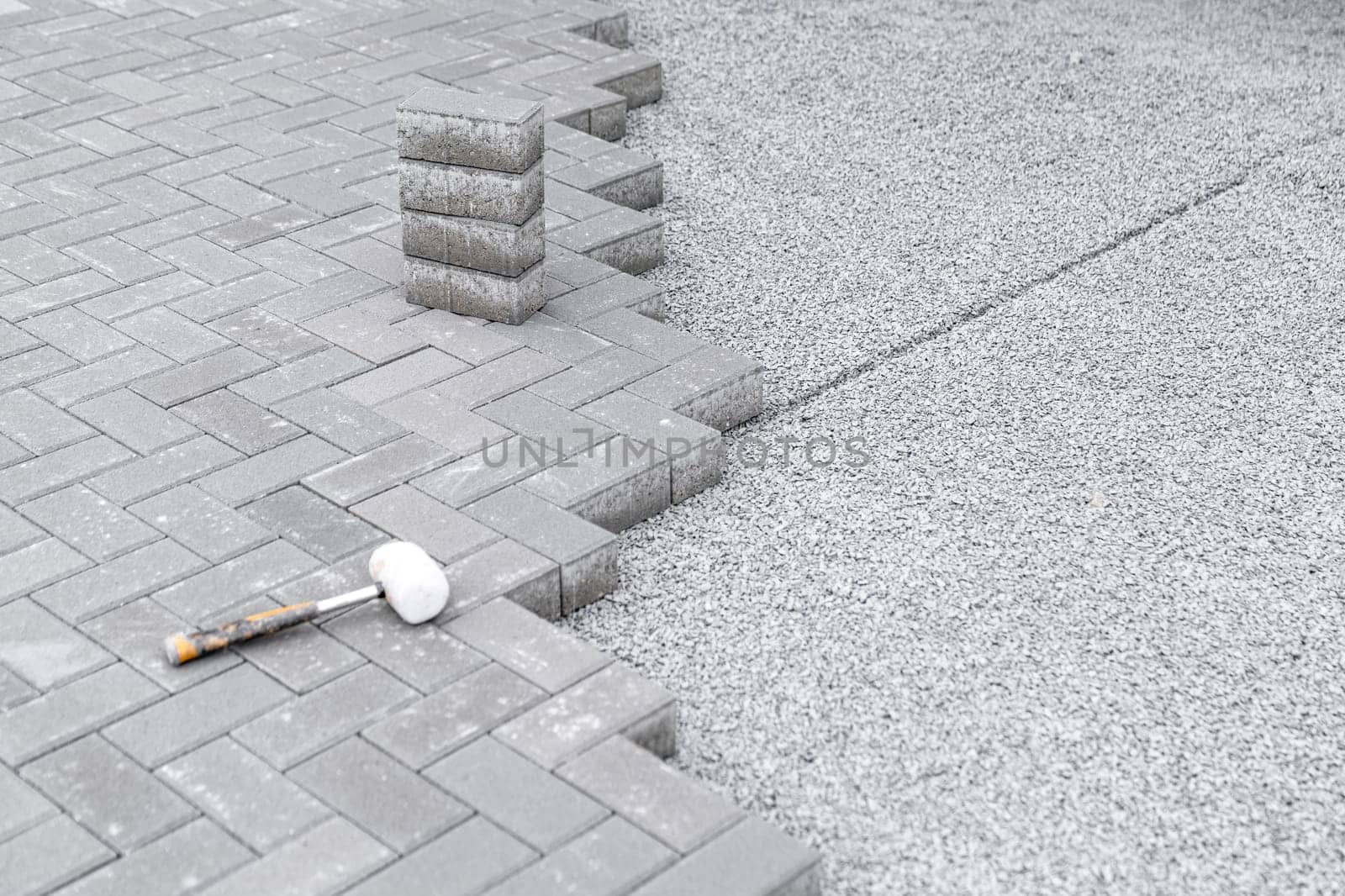 rubber hammer for adjusting the lock paving on the sidewalk. High quality photo