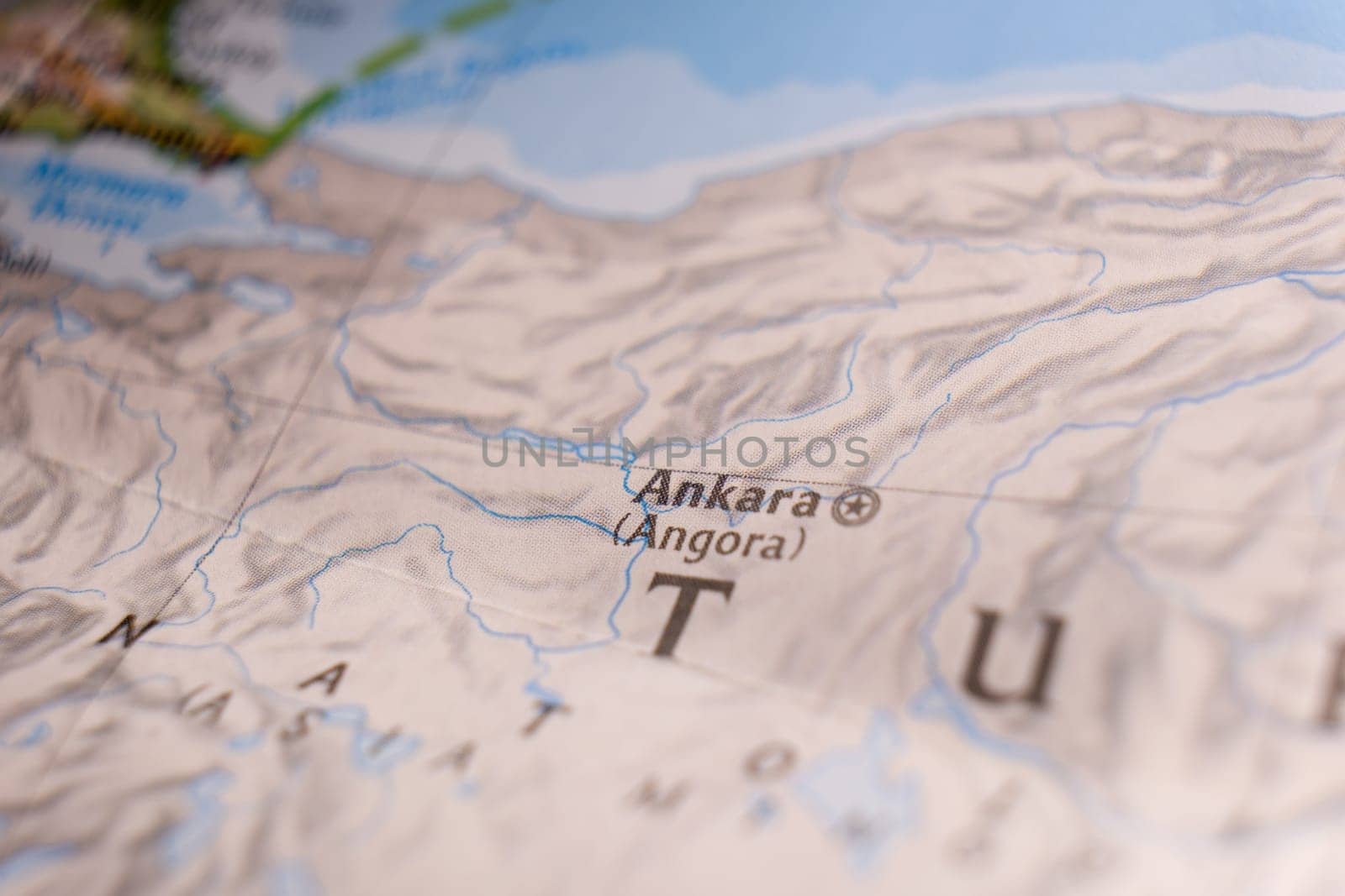 Close up of a colorful map focusing on Ankara, Turkey, through selective focus, background blur.
