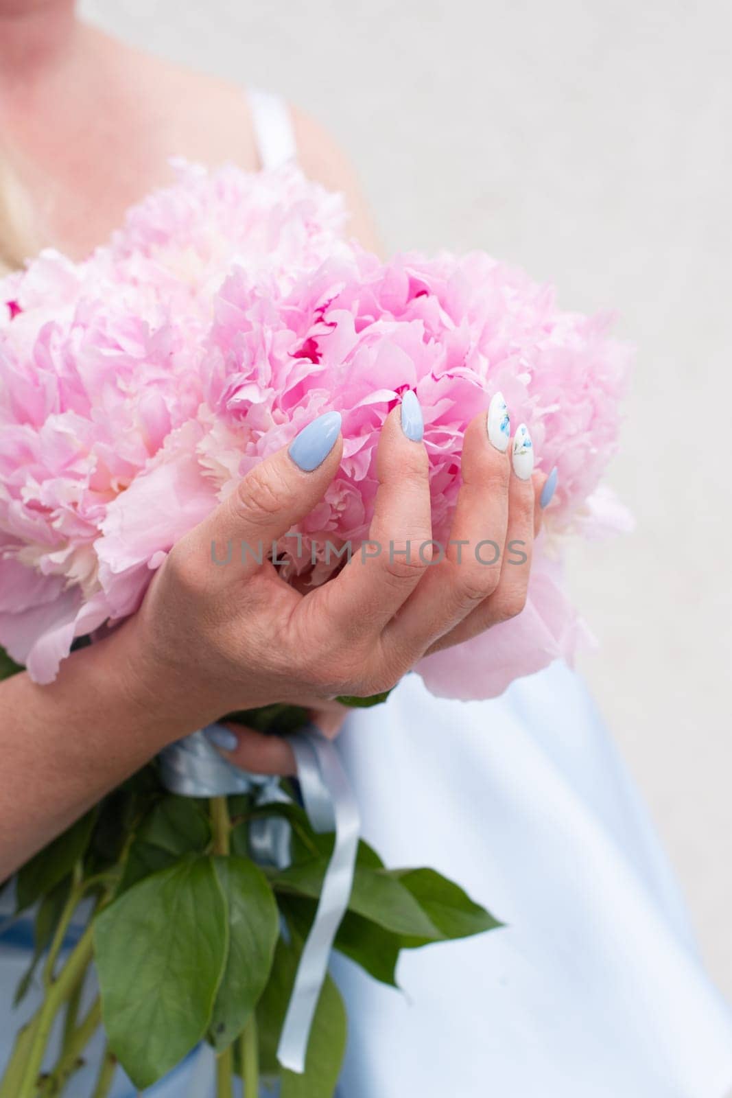 bride in a blue wedding dress with a bouquet of pink peonies, pastel paradise, floral background, complementary color combination. High quality photo