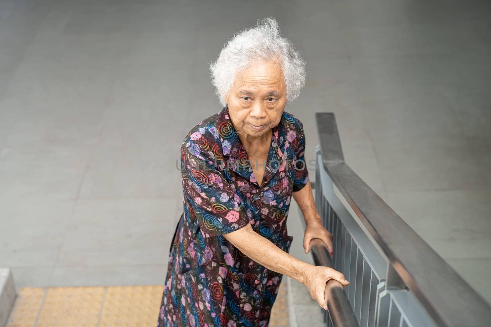 Asian senior woman patient use slope walkway handle security with help support assistant, healthy strong medical concept. by pamai