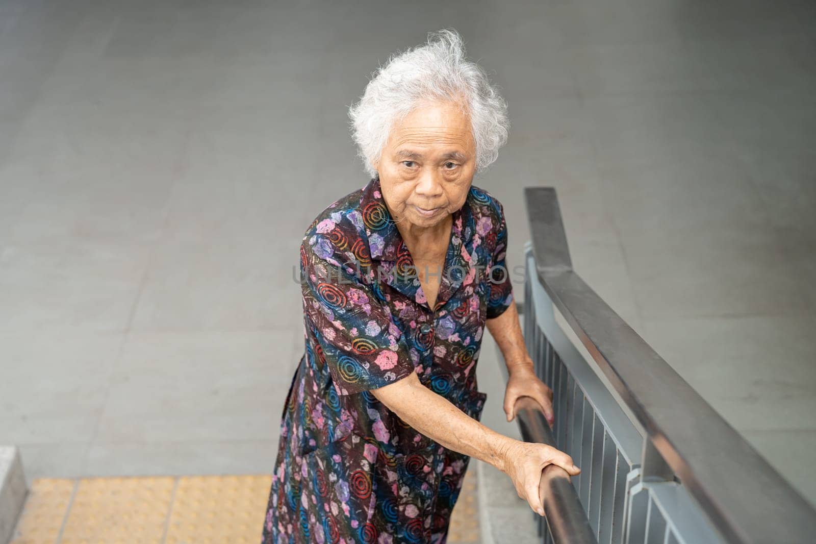 Asian senior woman patient use slope walkway handle security with help support assistant, healthy strong medical concept.