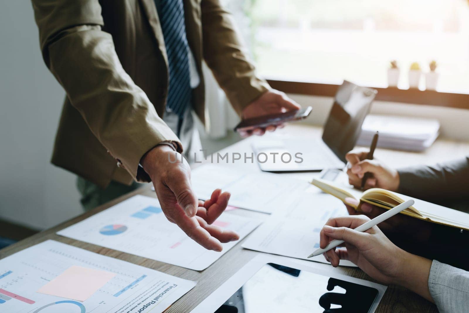 Asian entrepreneurs and business people meeting in a conference room in business planning, financial budget and investment risk assessment to analyze customer groups to increase company growth by Manastrong