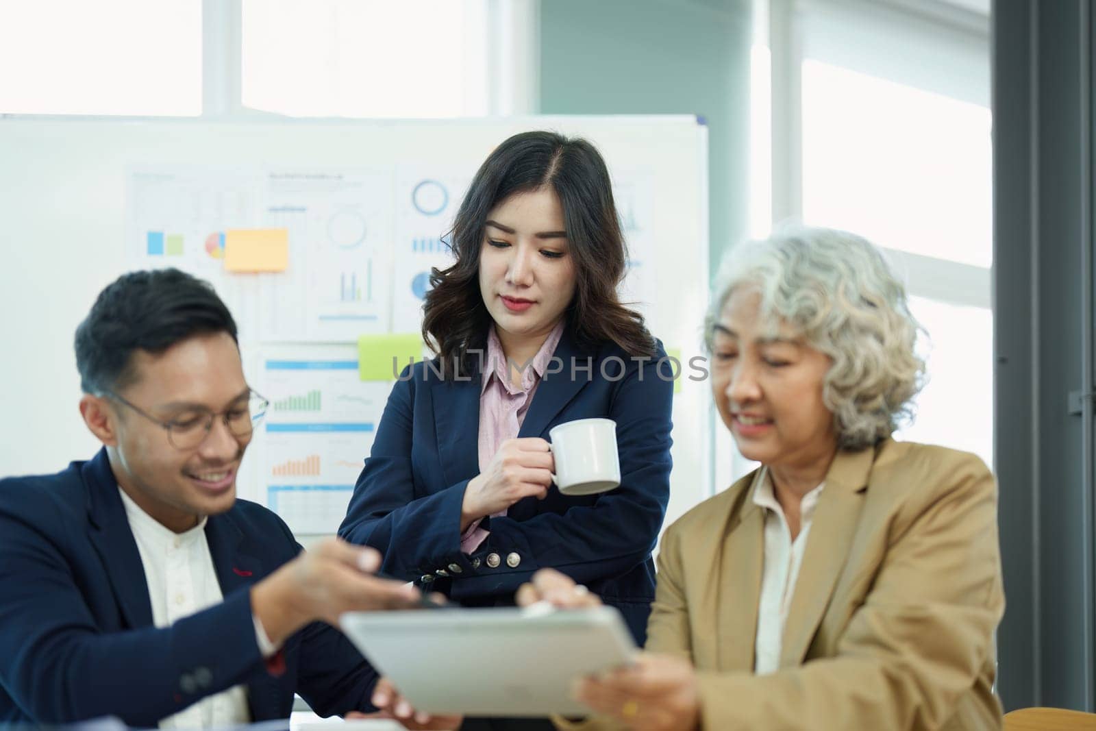 Asian entrepreneurs and business people meeting in a conference room in business planning, financial budget and investment risk assessment to analyze customer groups to increase company growth by Manastrong