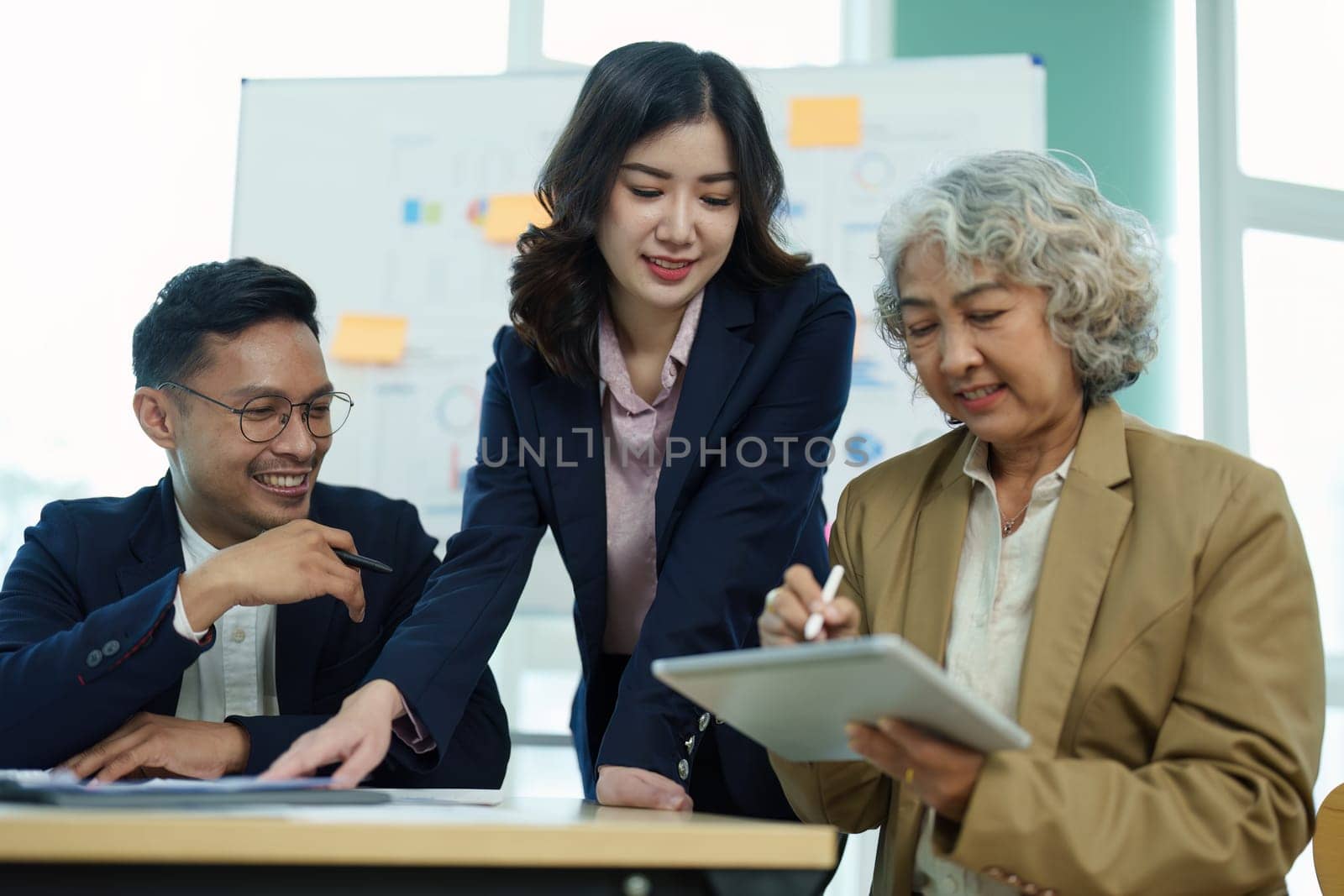 Asian entrepreneurs and business people meeting in a conference room in business planning, financial budget and investment risk assessment to analyze customer groups to increase company growth by Manastrong