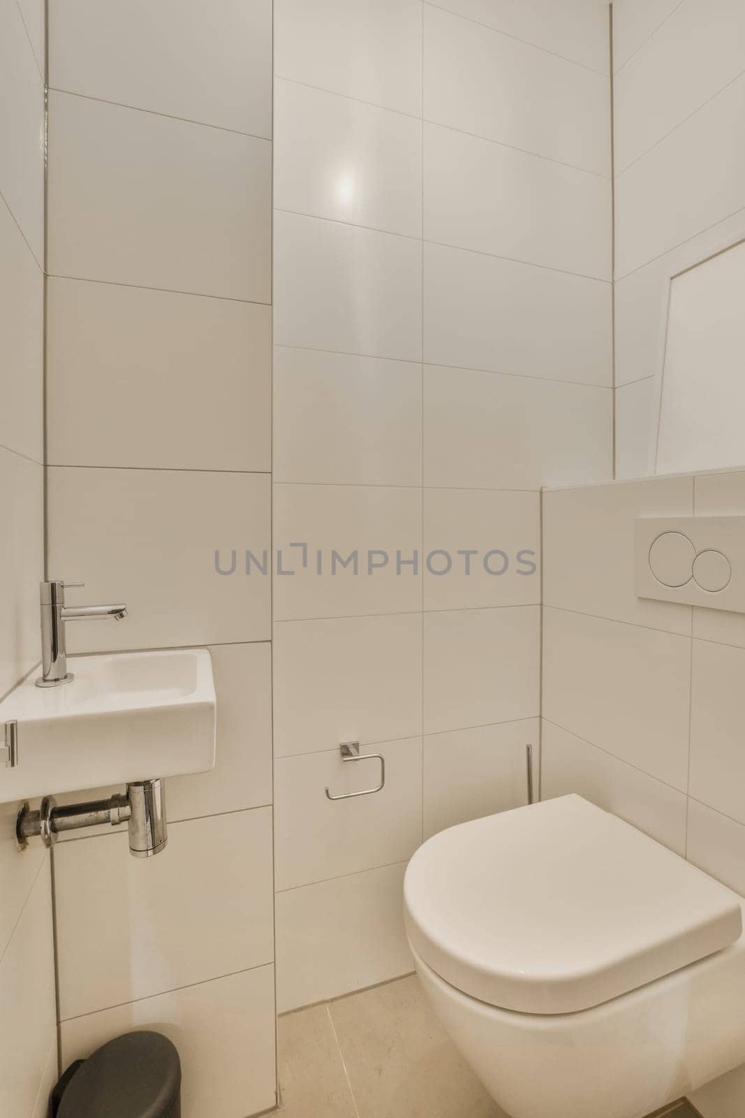 a white bathroom with a toilet and a sink by casamedia