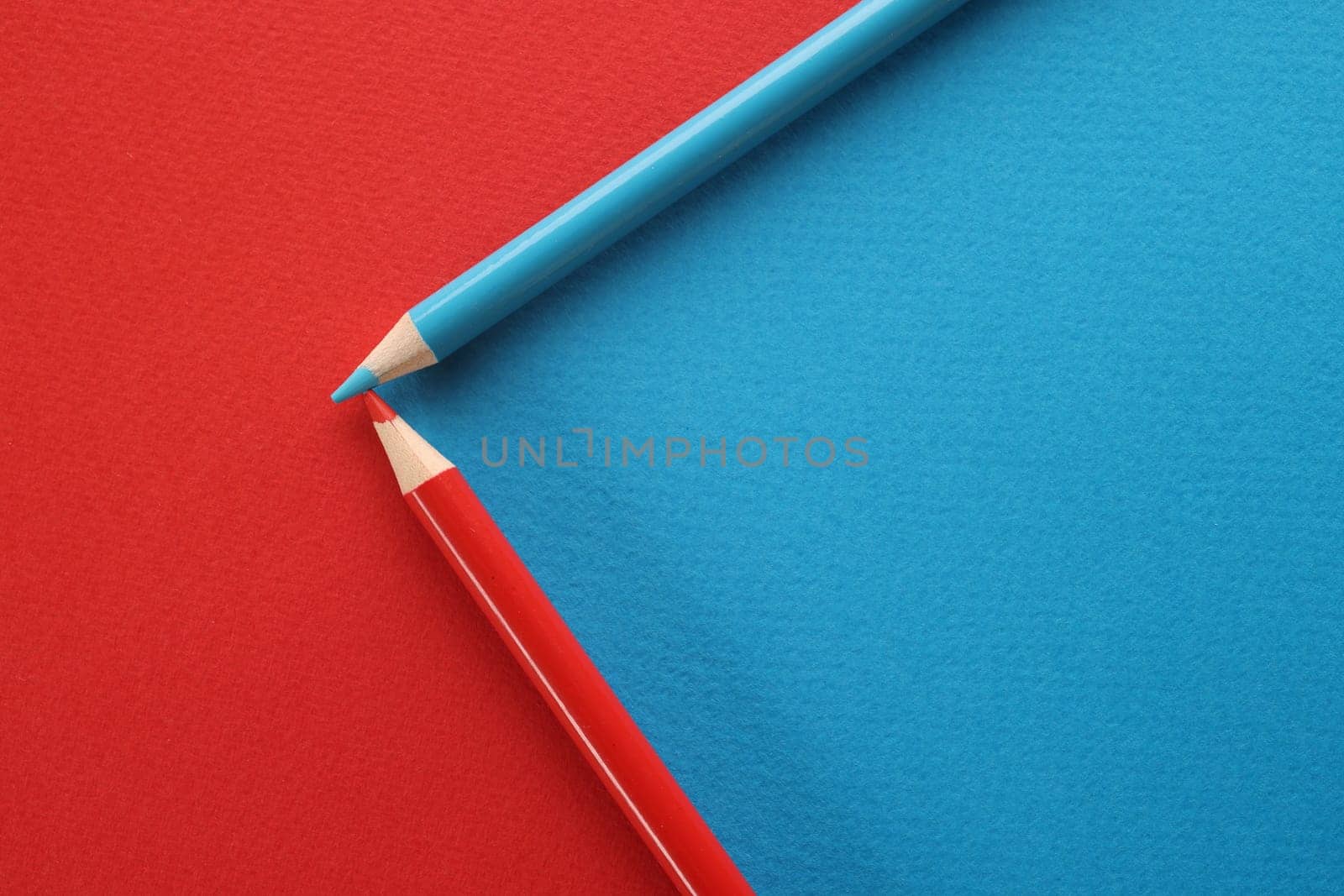 Blue and red pencils on red and blue background by kuprevich