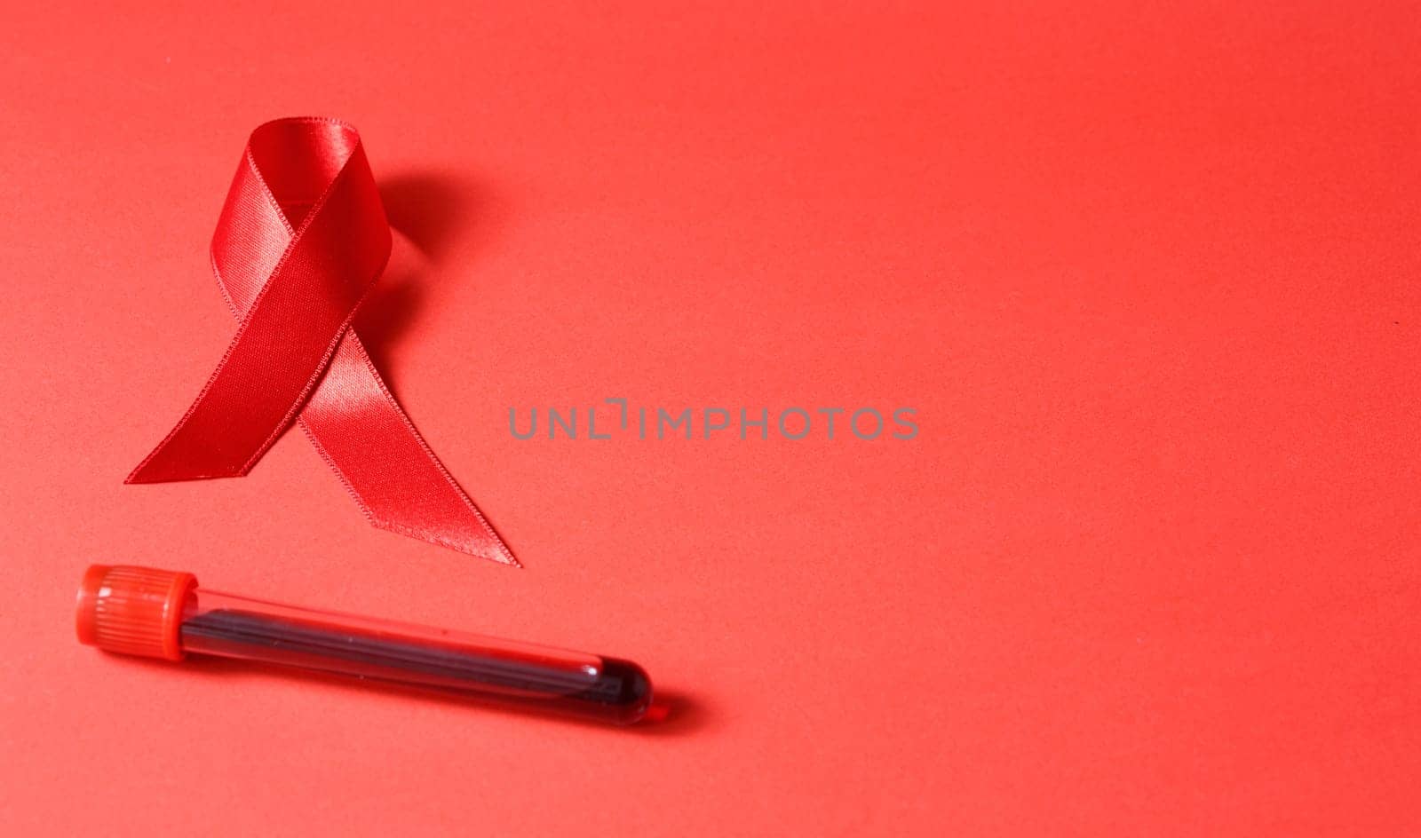 Sign of cancer red ribbon on the table. by alexxndr