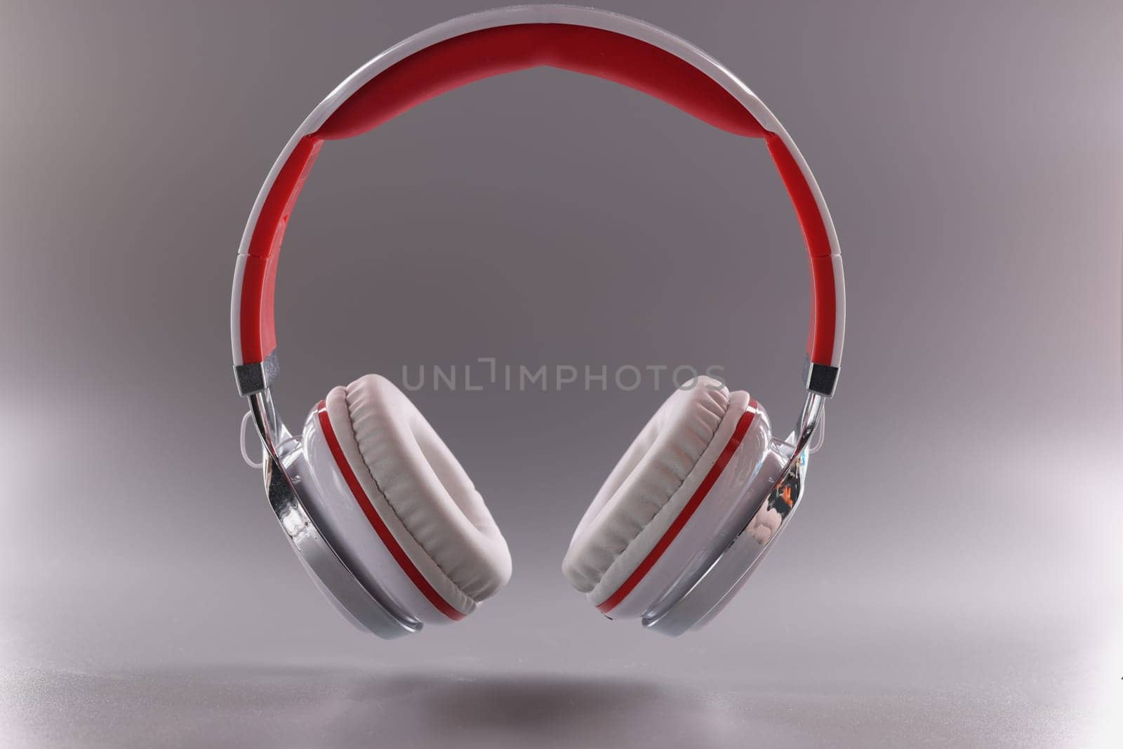 White red modern headphones on gray background. Headphones-headset for computer and phone concept