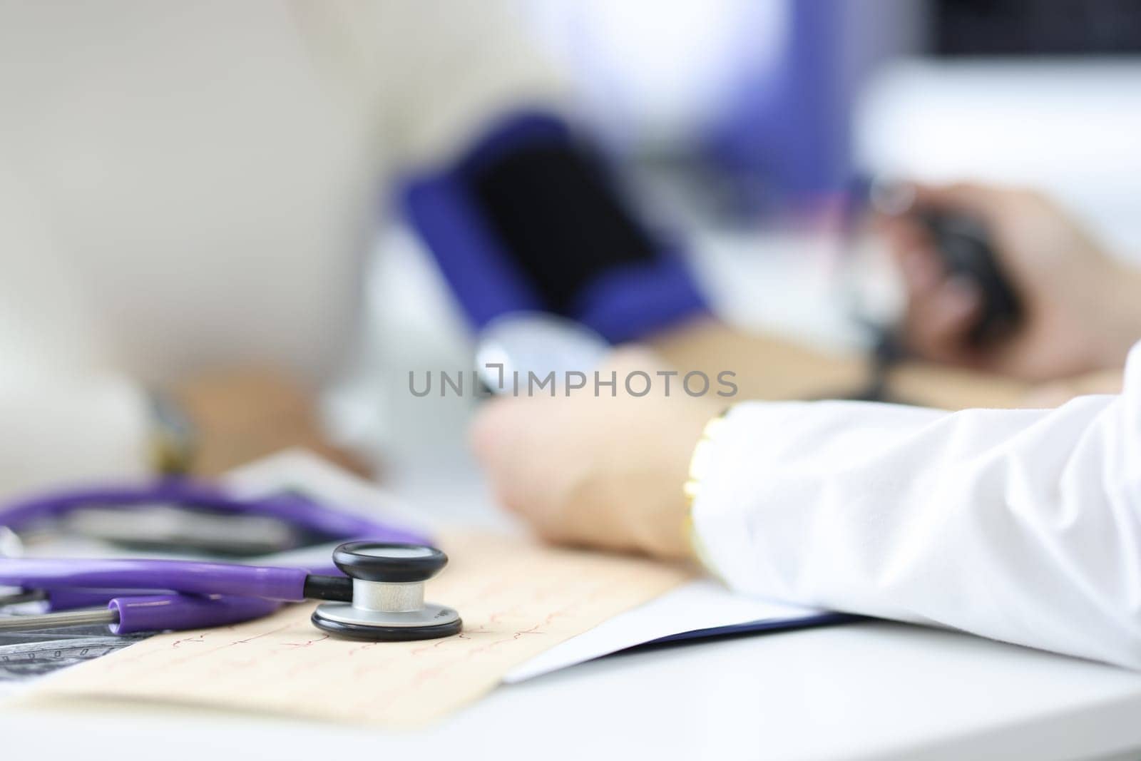 Cardiologist measures blood pressure in cardiology department of hospital. Electrocardiogram and control of pressure and heartbeat