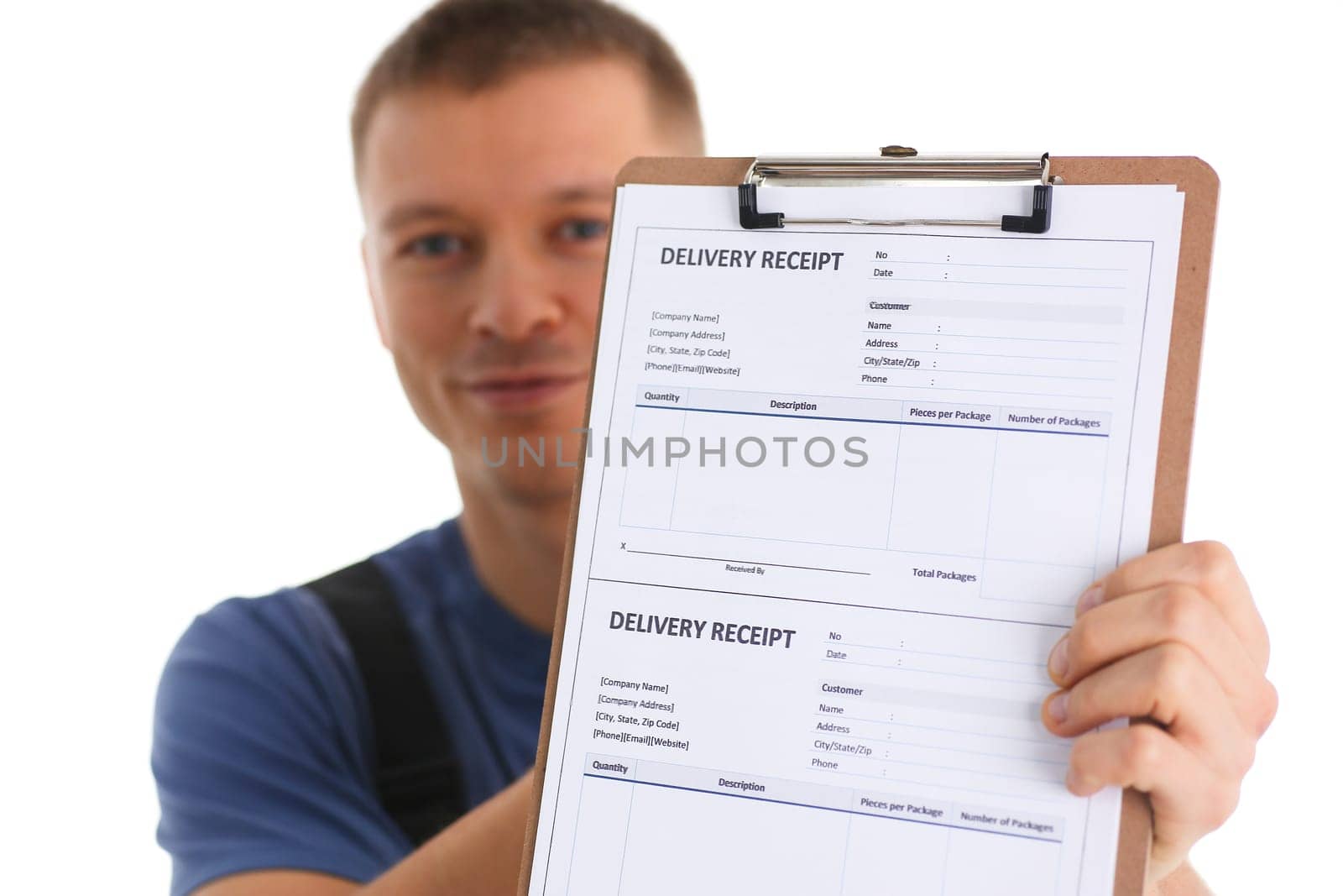 Delivery man holds clipboard with delivery receipt in hands. Courier logistics and delivery of goods concept