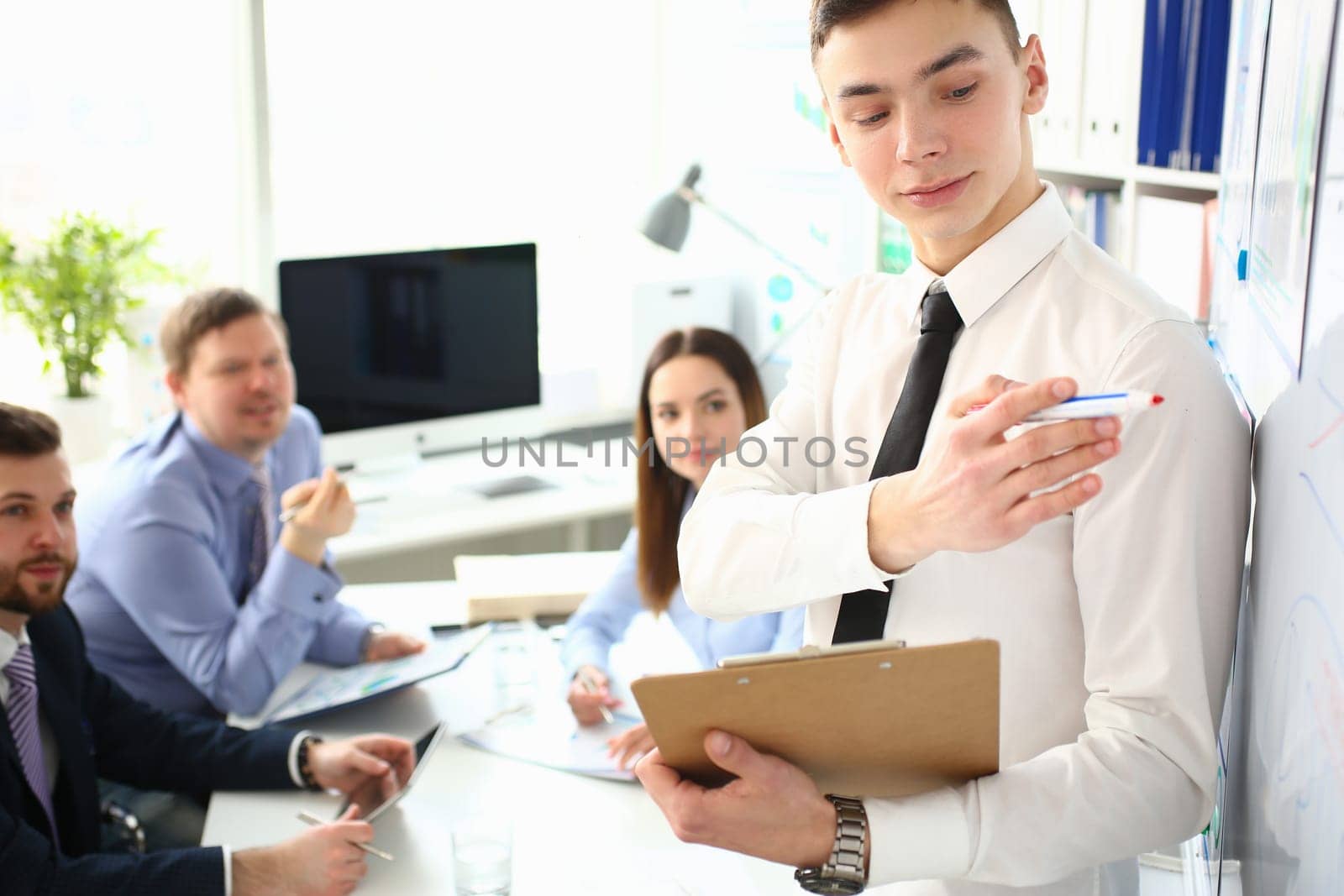 Young male business coach speaker giving presentation by kuprevich