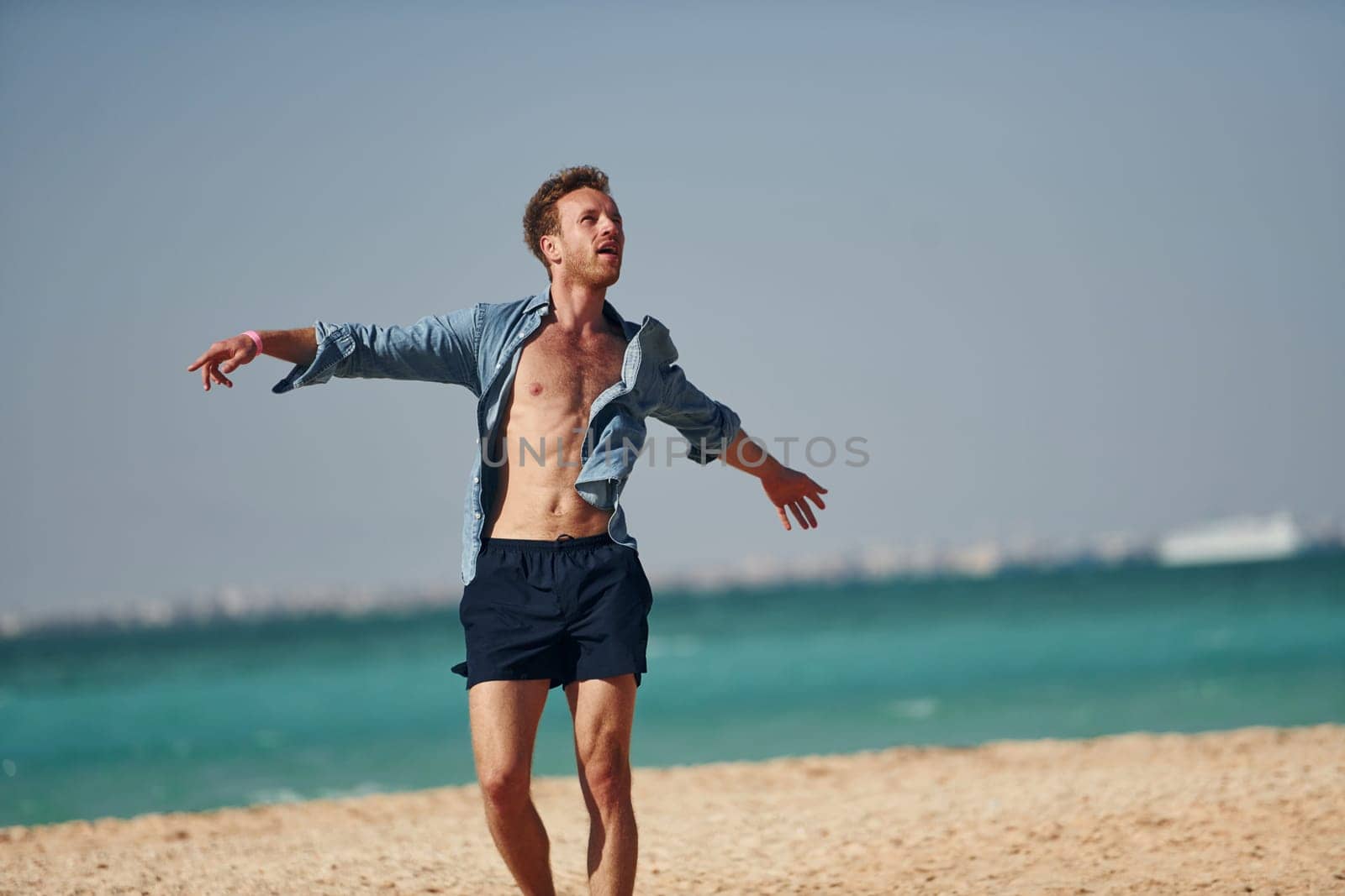 Having fun. Young european man have vacation and enjoying free time on the beach of sea.