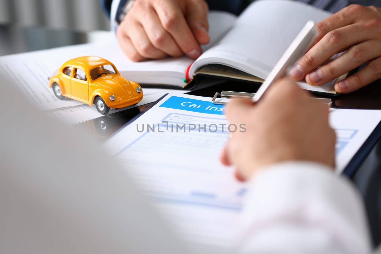 Customer signing a car insurance document or paper lease agreement or agreement. Buying or selling new or used car concept