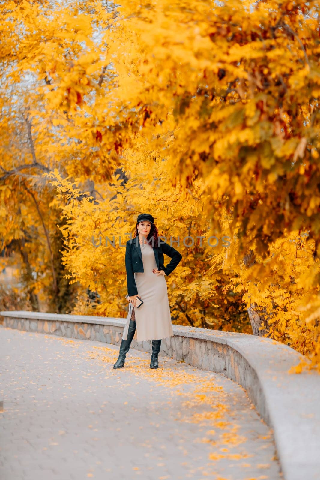 A woman walks outdoors in autumn, enjoys the autumn weather