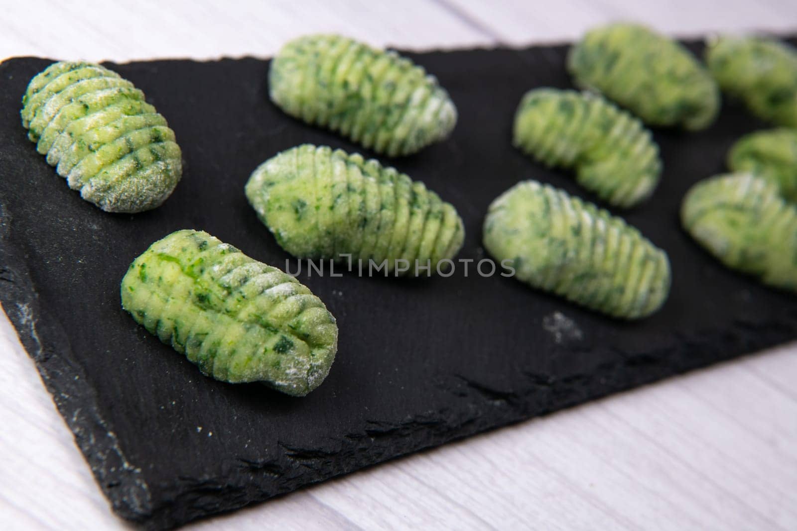 Pile of green spinach gnocchi, potato peru italian food, Homemade, High quality photo