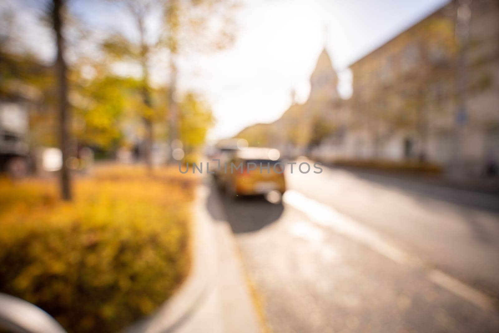 Autumn season bokeh background. Abstract city blur along the road with cars. by Matiunina