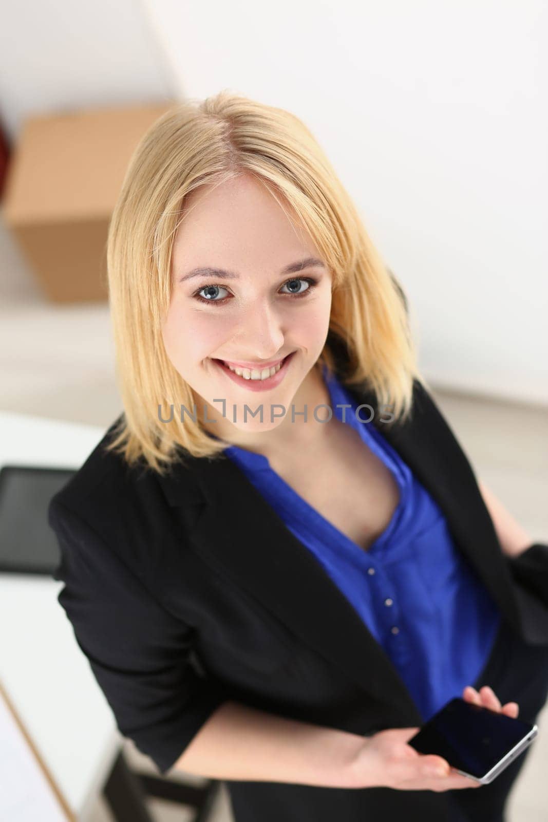 Beautiful smiling business woman holding smartphone. Applications for business and personal business consultant