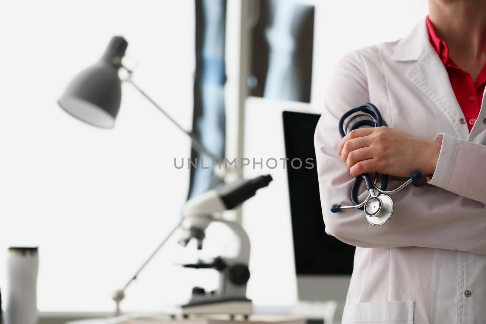 Doctor cardiologist or therapist with stethoscope in medical office. Health insurance concept