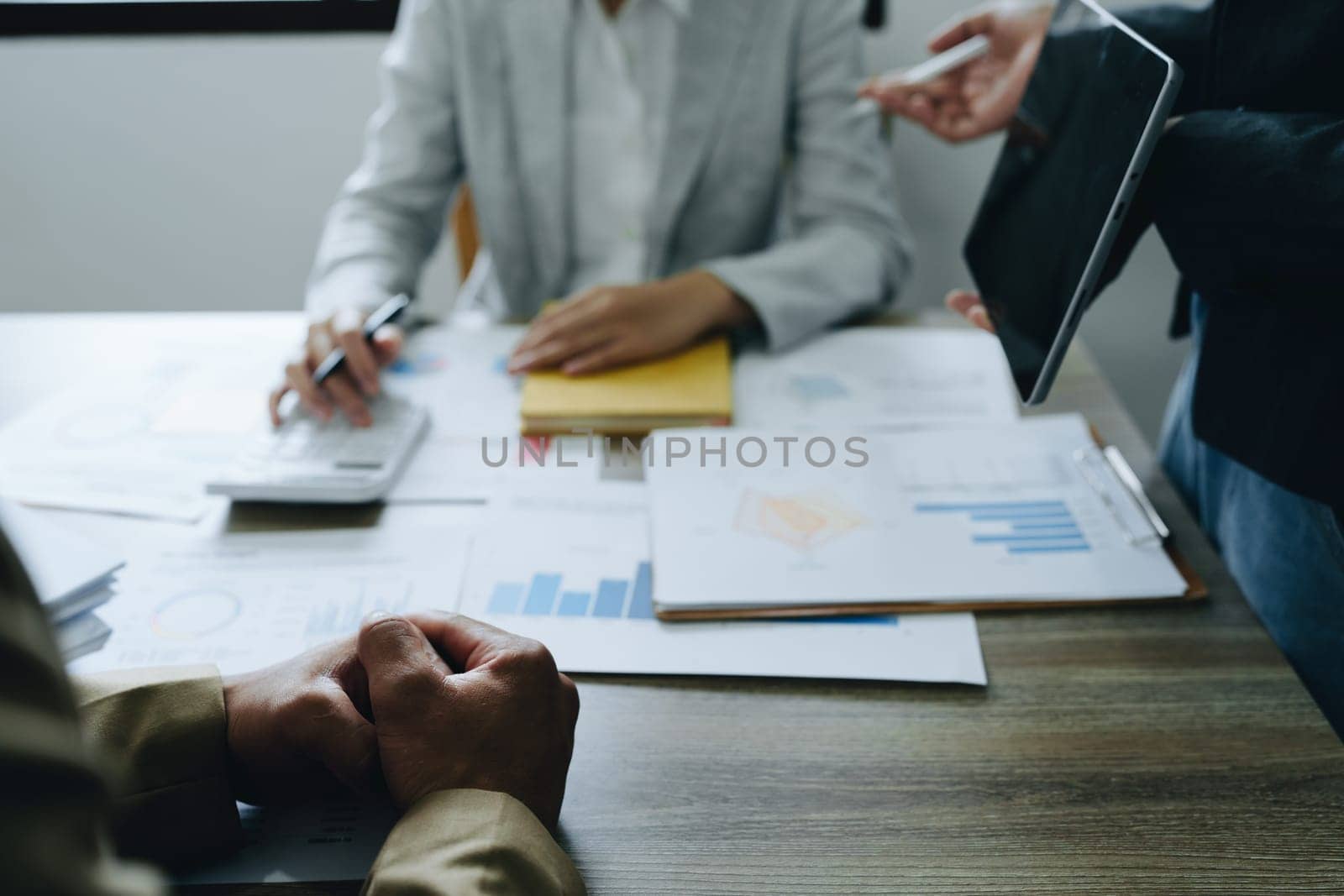 Asian entrepreneurs and business people meeting in a conference room in business planning, financial budget and investment risk assessment to analyze customer groups to increase company growth by Manastrong