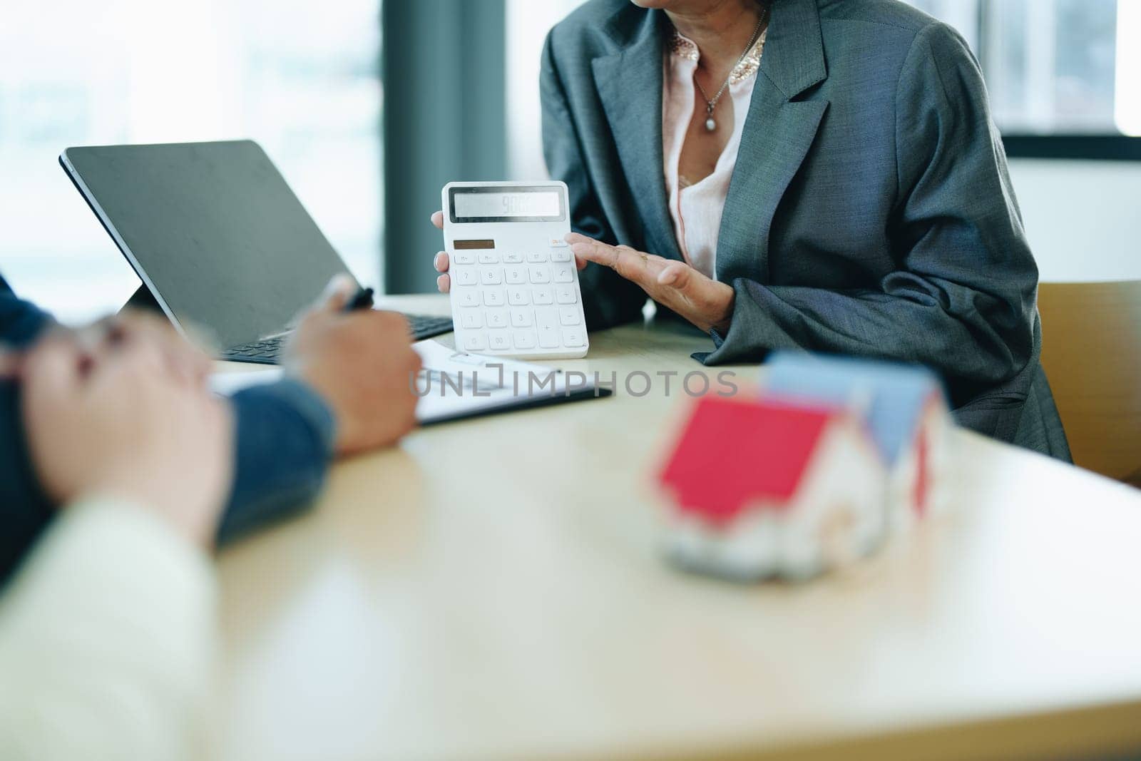 Guarantee Insurance Sign a contract, couple a smiling couple is signing a contract to invest in real estate with the Mortgage officer with the bank by Manastrong