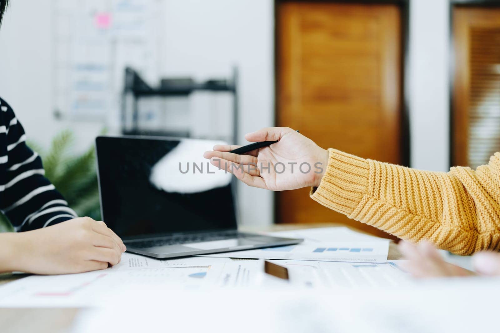 Asian entrepreneurs and business people meeting in a conference room in business planning, financial budget and investment risk assessment to analyze customer groups to increase company growth by Manastrong