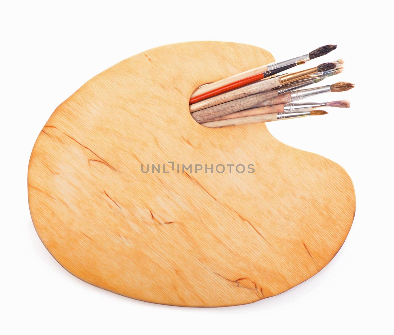 Wooden art palette with paints and brushes, isolated on white background