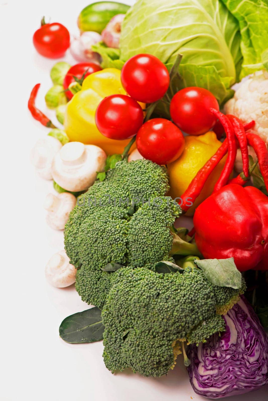 Fresh raw tomatoes, broccoli, peppers and cabbage on a light wooden background. Healthy Organic Vegetables on a Wooden Background by aprilphoto