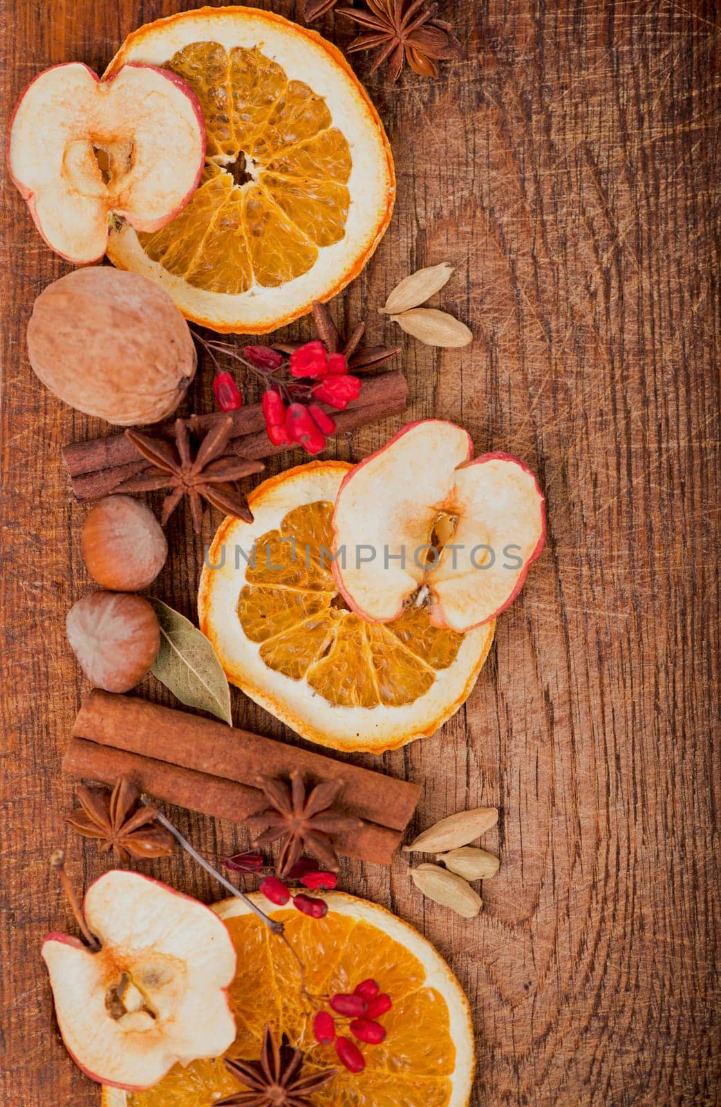 Christmas frame. Spices and dried orange sliceson on a wooden table