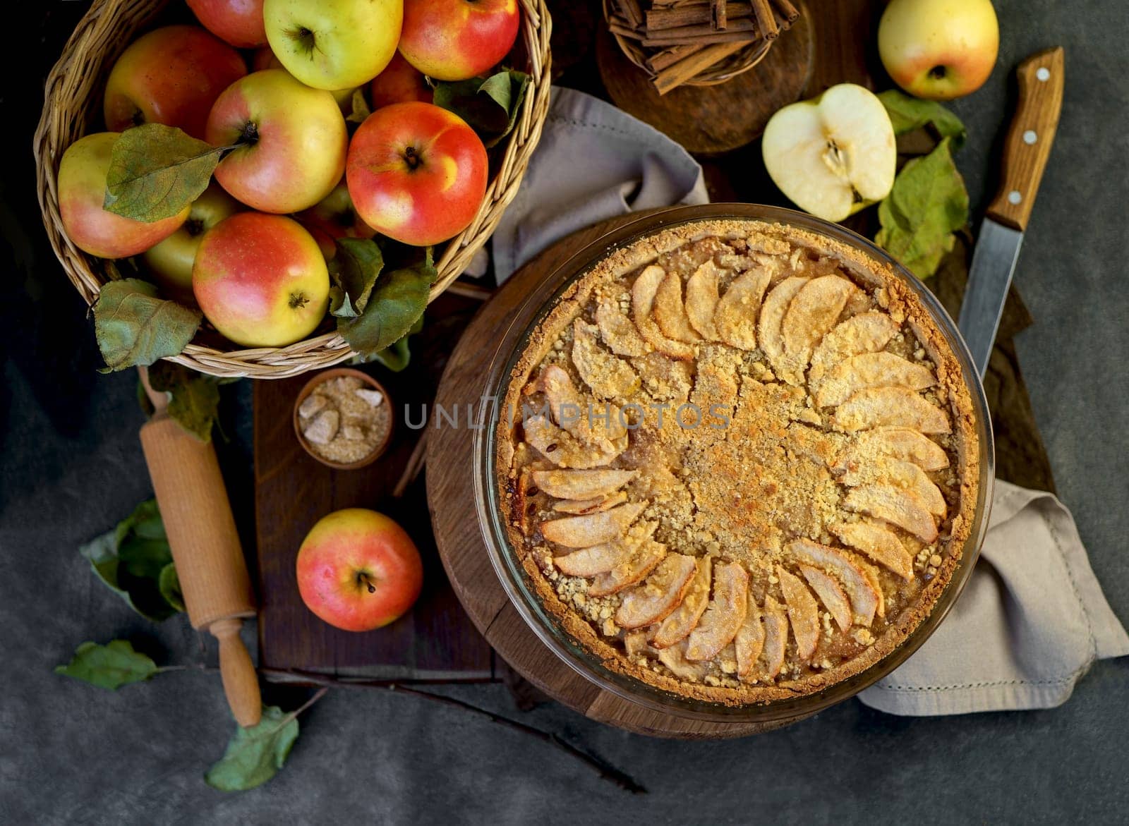 apple pie with fresh fruits on a wooden table by aprilphoto