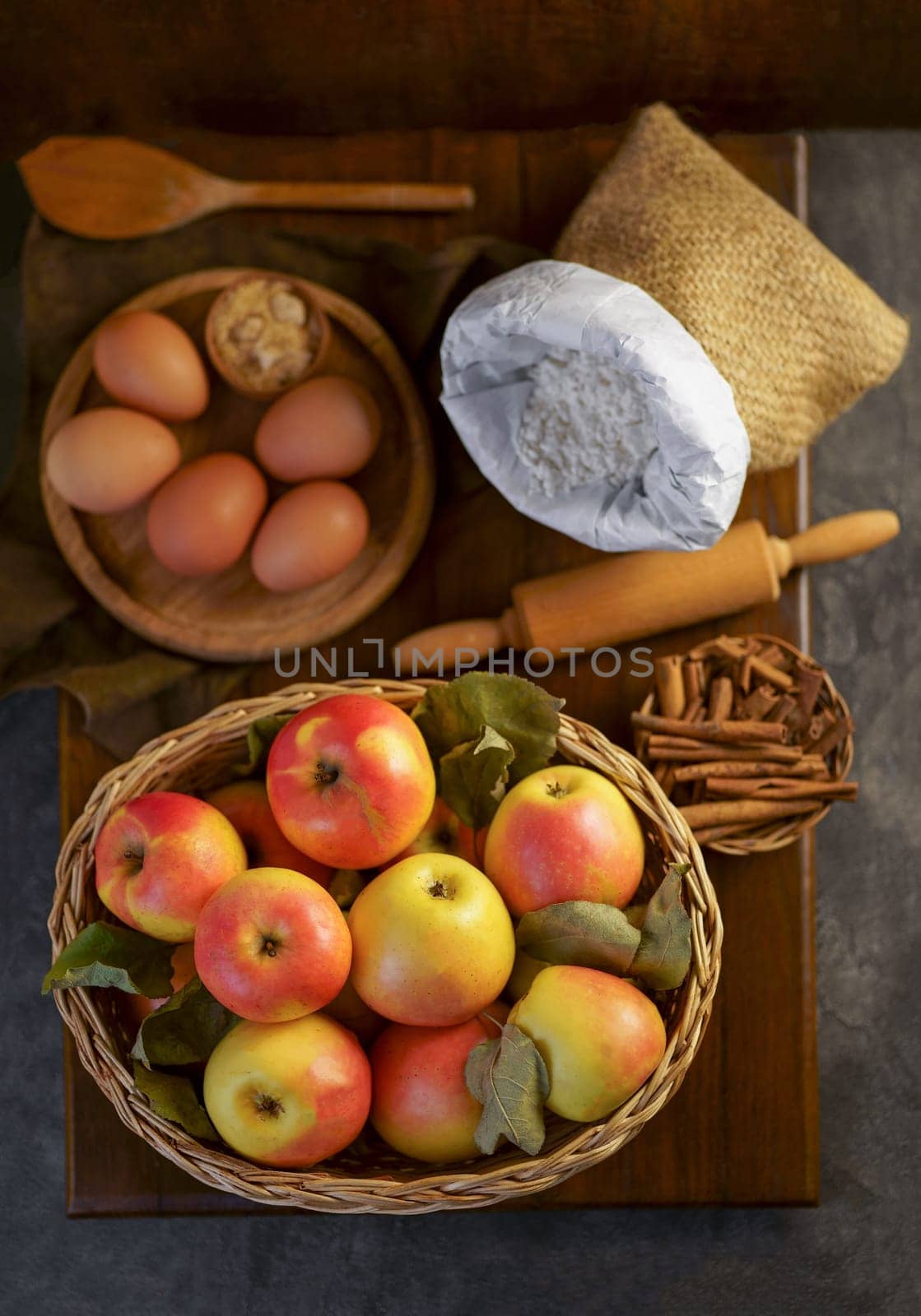 preparation to bake an apple pie on a wooden table by aprilphoto