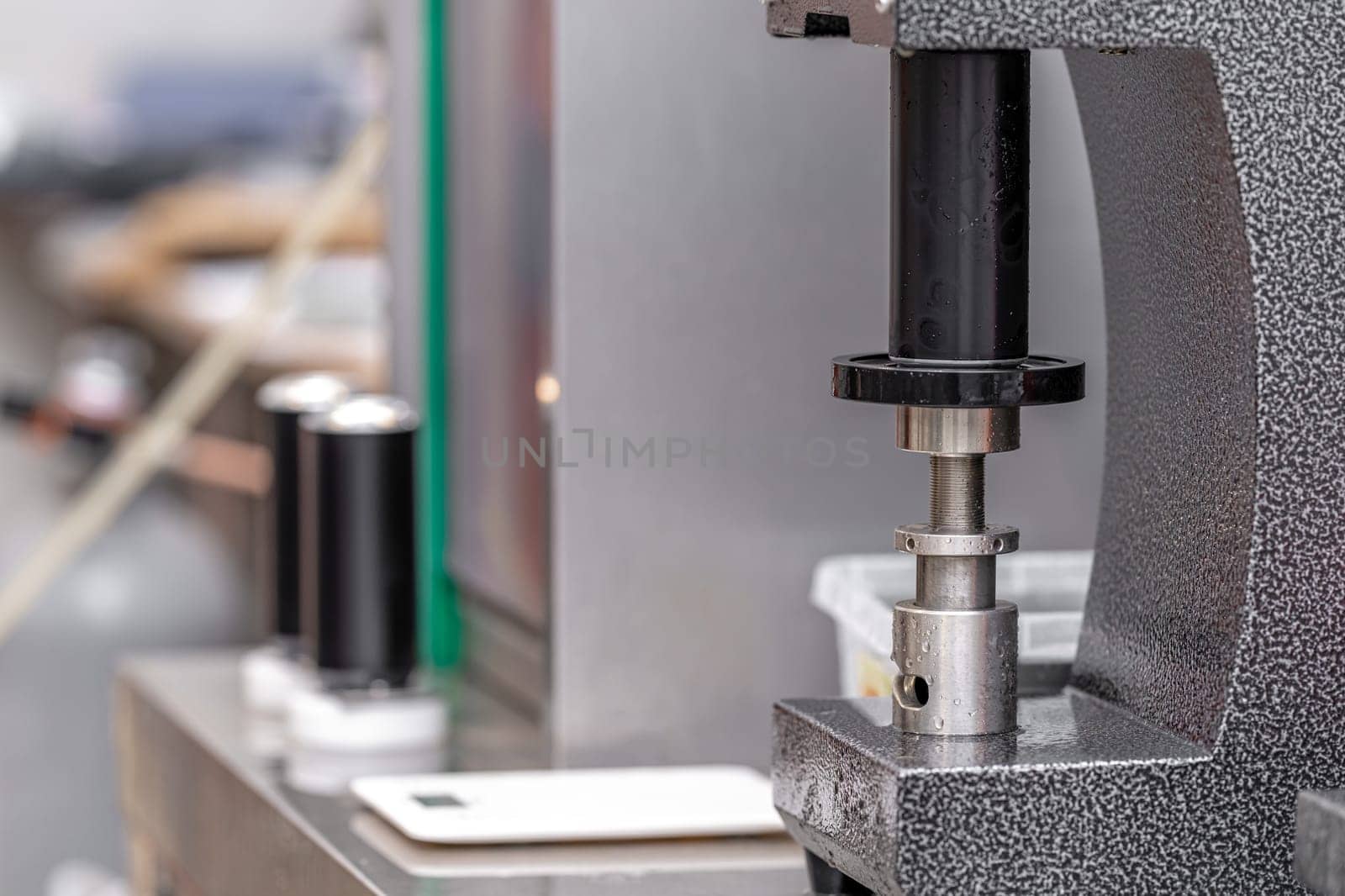 closed with the lid of beverage cans in an automatic capping machine in a brewery.