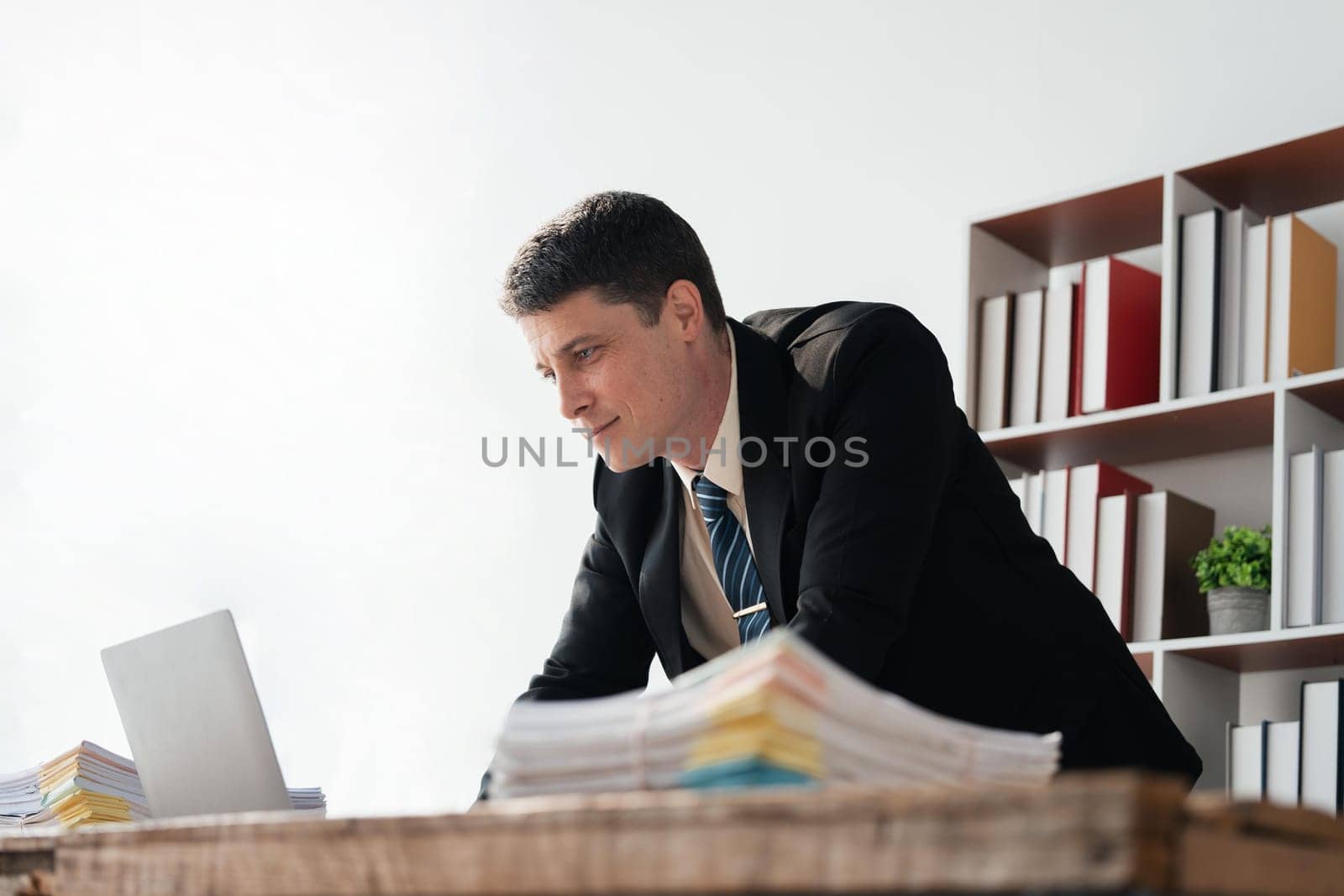 Young businessman working with laptop at office.