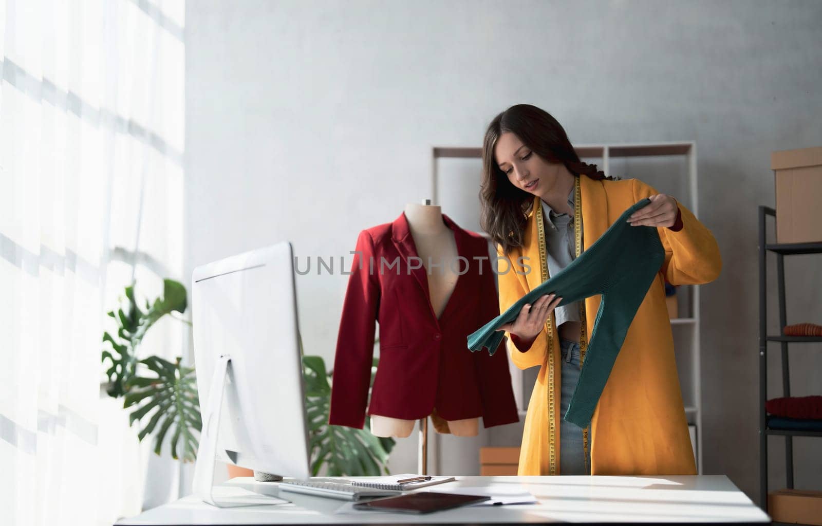 Portrait of young beautiful asian woman fashion designer stylish stand and working with color samples.Attractive young asian girl working with colorful
