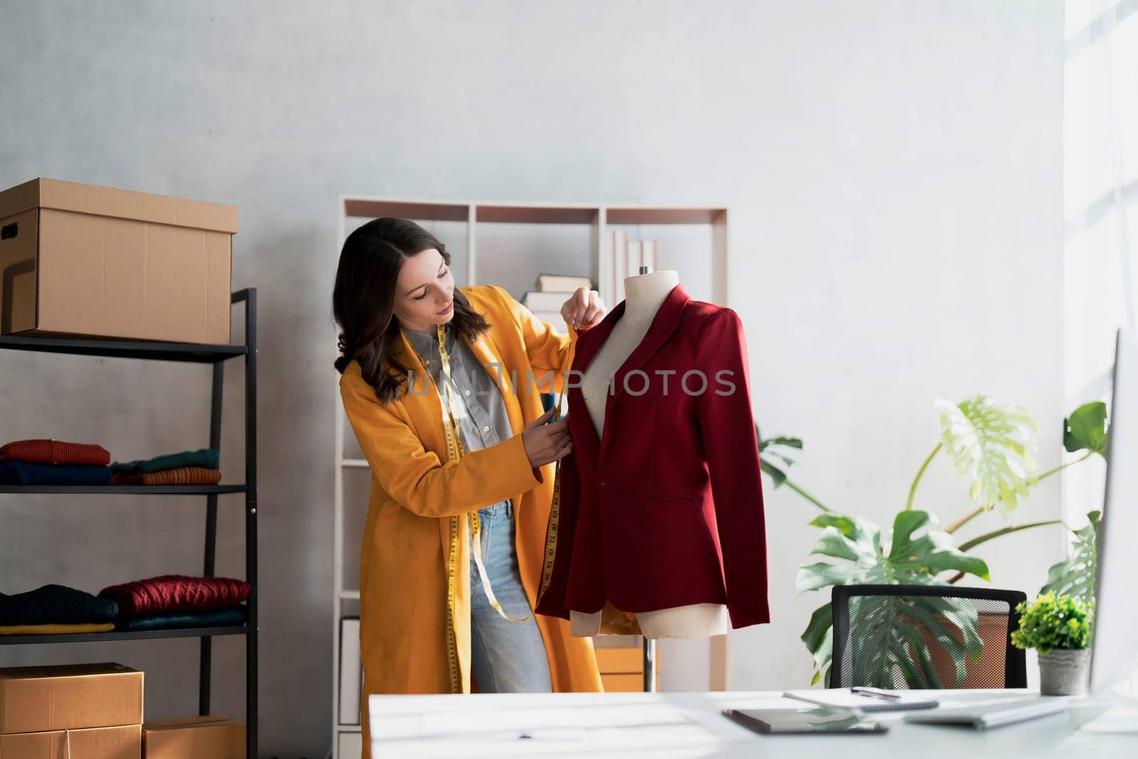 Portrait of young beautiful asian woman fashion designer stylish stand and working with color samples.Attractive young asian girl working with colorful fabrics at fashion studio by wichayada