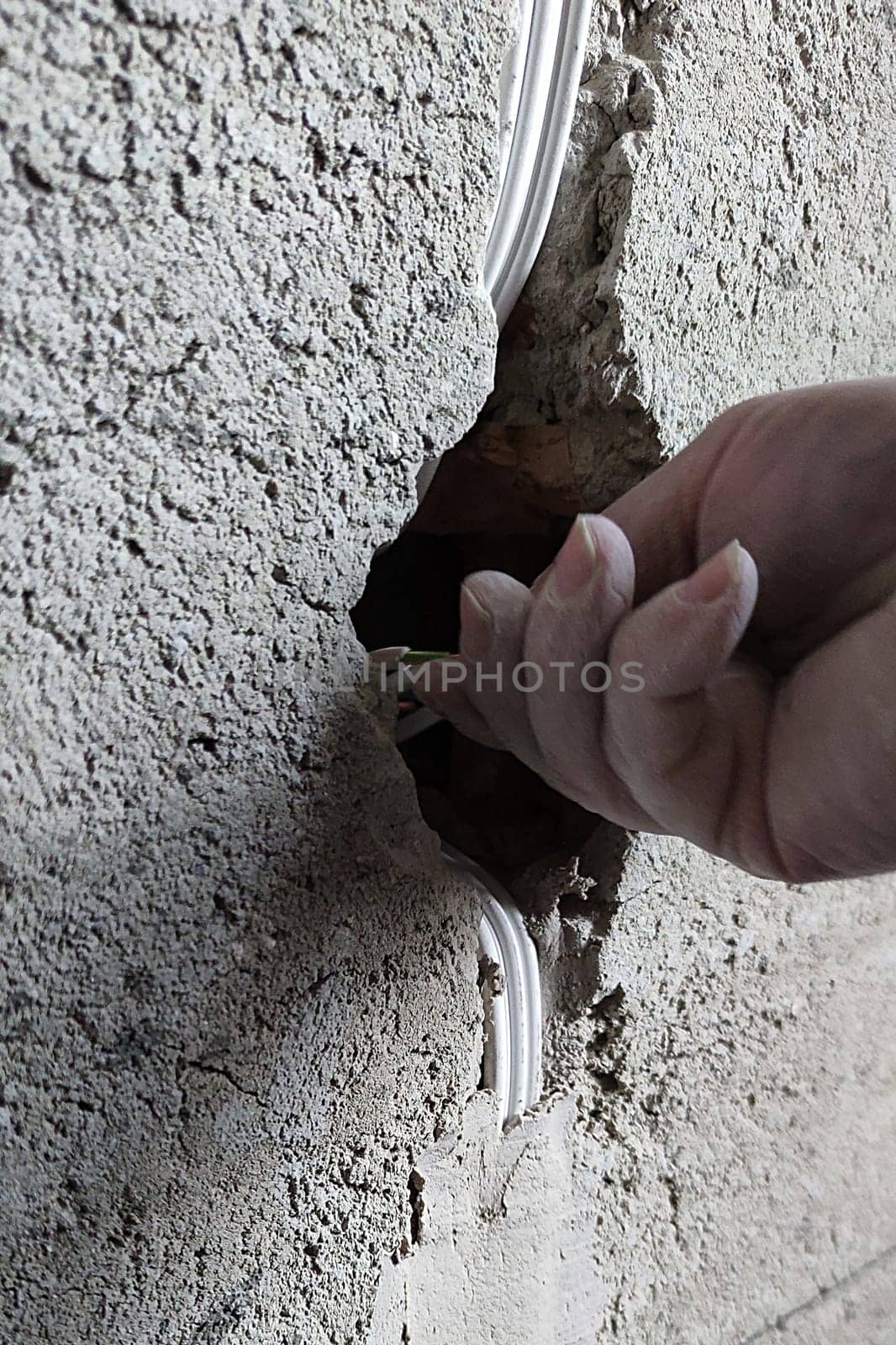 installation of an electrical outlet in a concrete wall by Annado