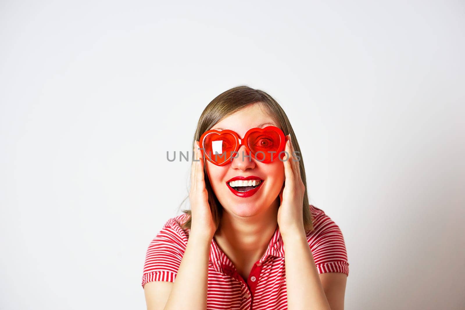 Valentines Day portrait of pretty smiling woman in red sunglasses on the white background. by tanjas_photoarts