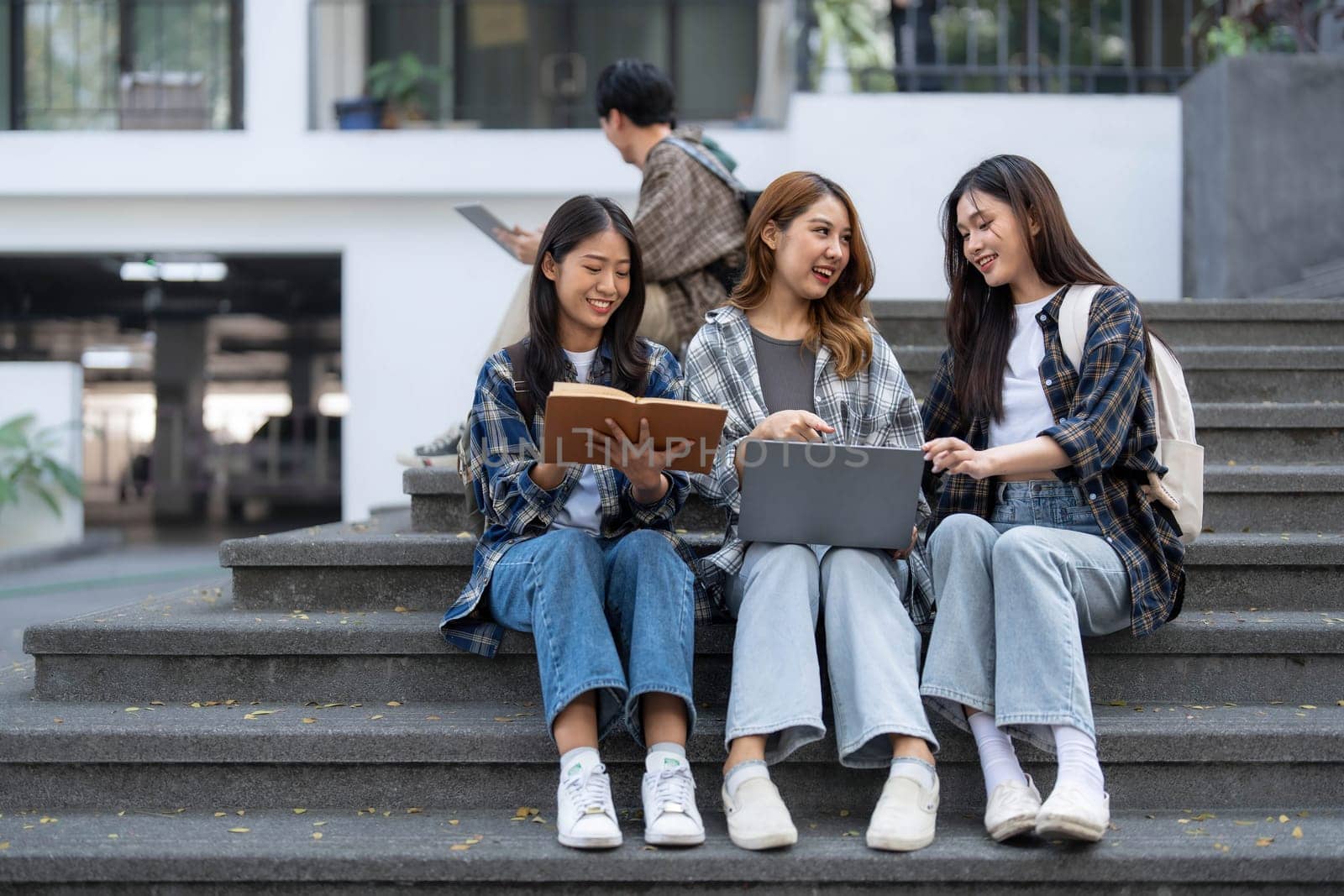 Group of Asian college student reading books and tutoring special class for exam on grass field at outdoors. Happiness and Education learning concept. Back to school concept. Teen and people theme...