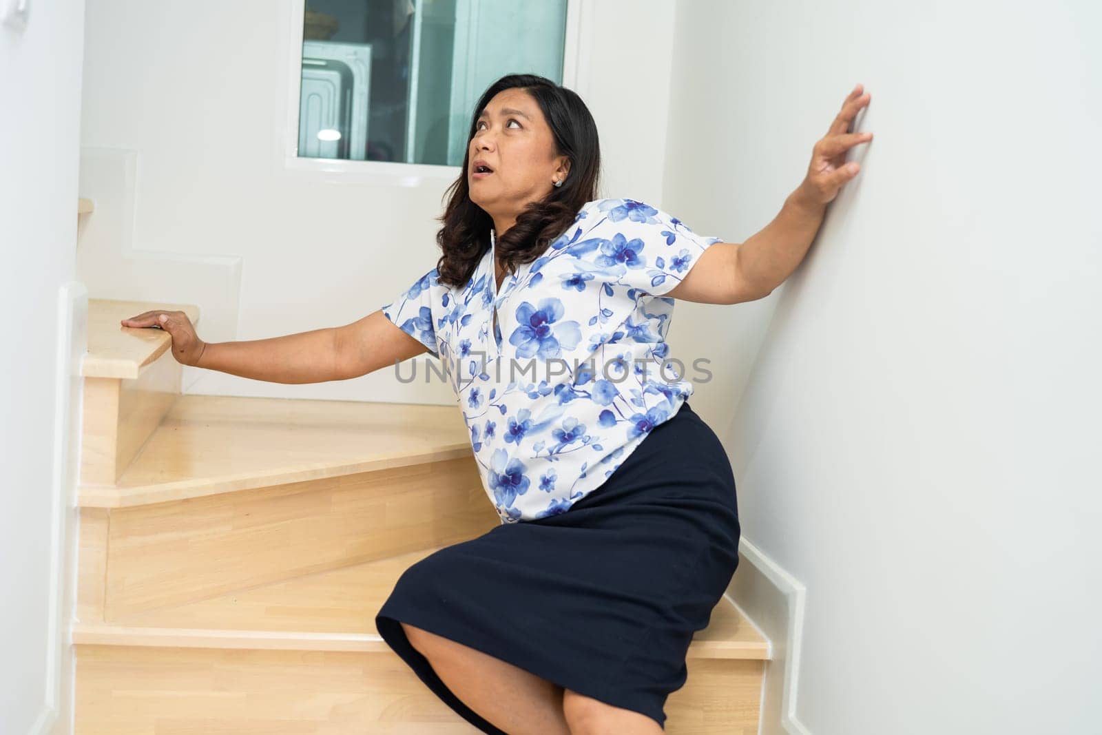 Asian lady fall down the stairs and pain at hip and waist because slippery surfaces.