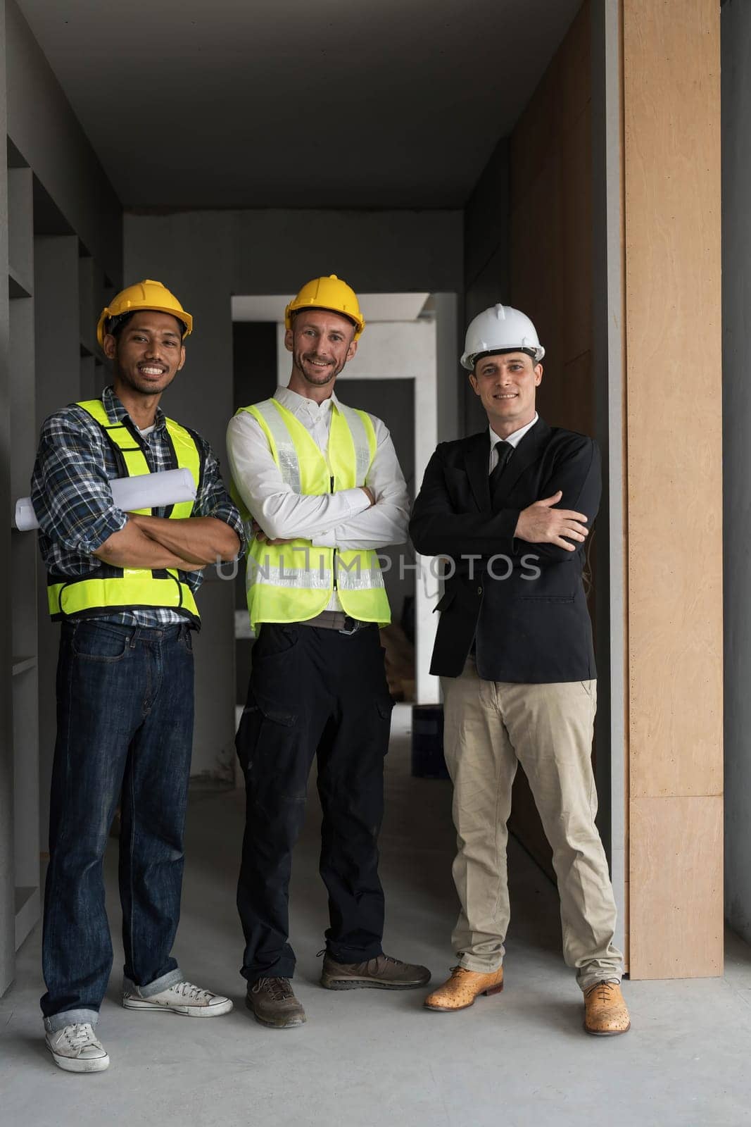 Civil engineer teams meeting working together wear worker helmets hardhat on construction site in modern city. Foreman industry project manager engineer teamwork. Asian industry professional team. by wichayada