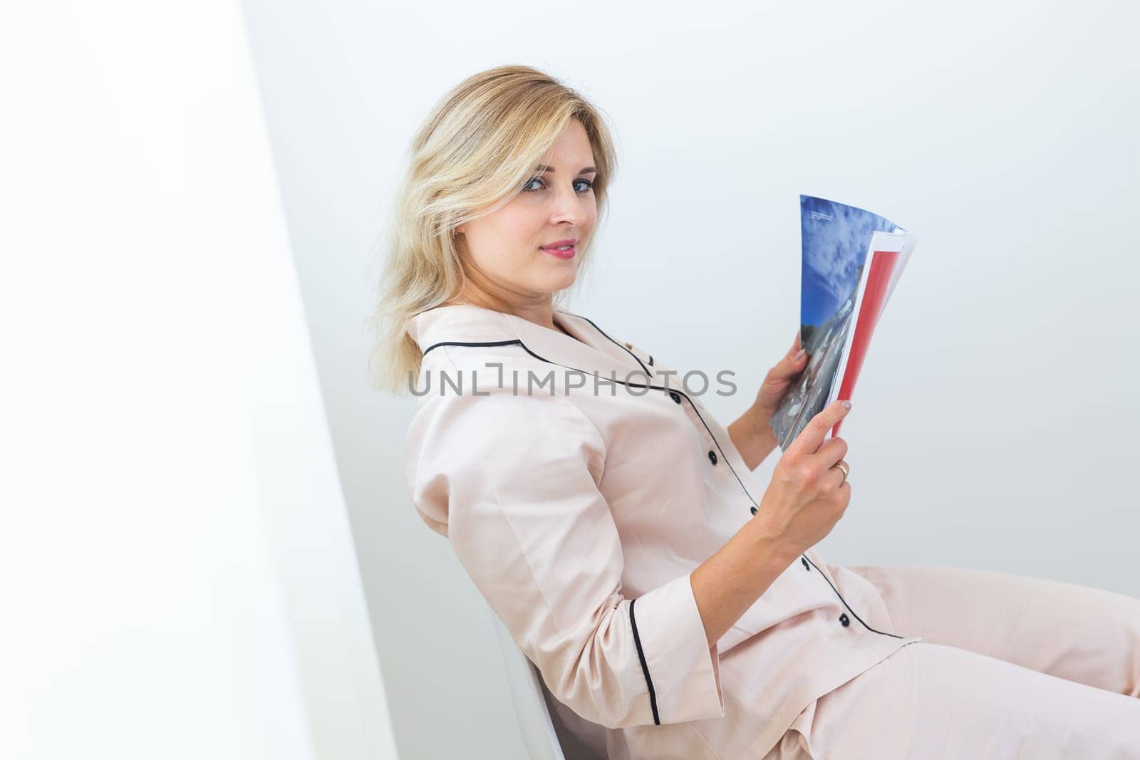 Woman wears pajama reads magazine in living room. Homewear, sleepwear, shopping and sale by Satura86