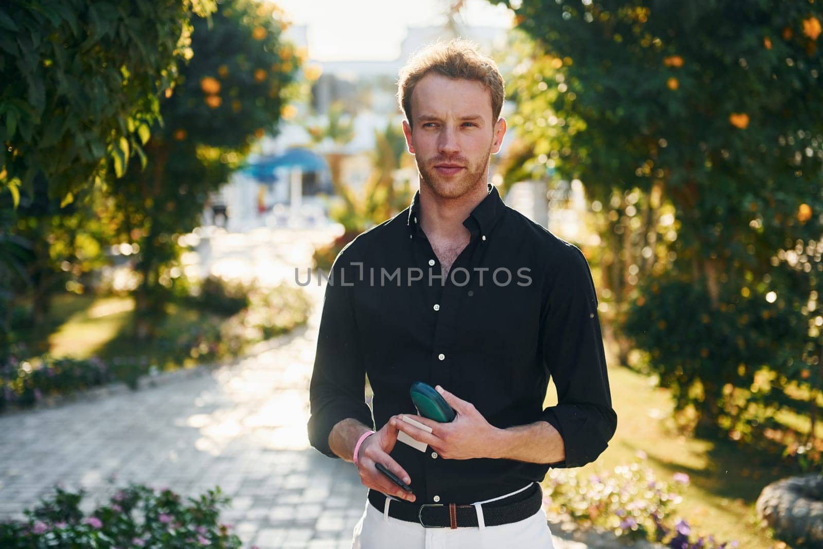 Young man is outdoors at sunny daytime. Concept of vacation.