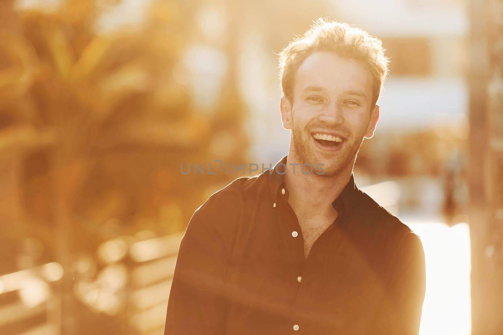 Beautiful nature. Young man is outdoors at sunny daytime. Concept of vacation.
