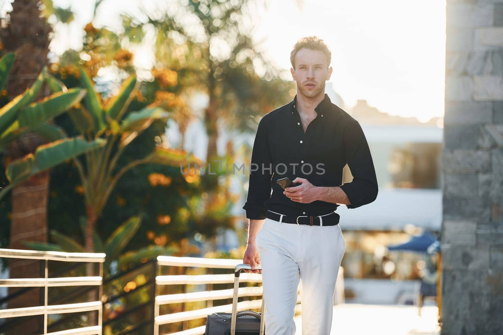Beautiful nature. Young man is outdoors at sunny daytime. Concept of vacation.