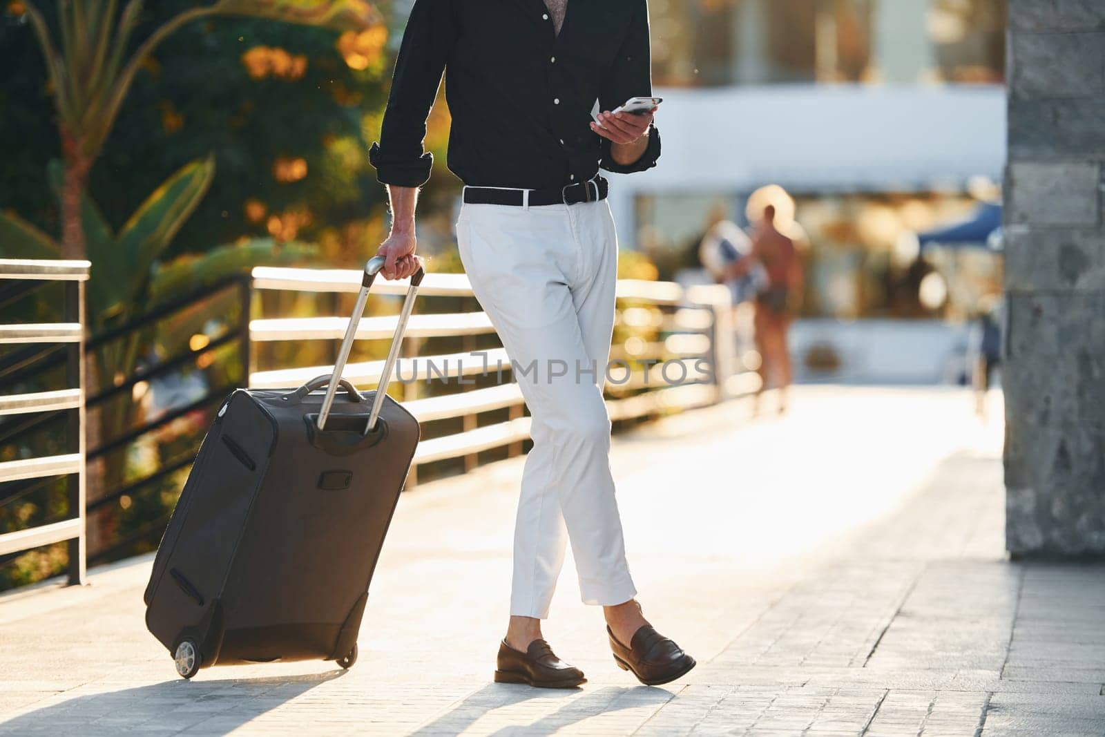 Young man is outdoors at sunny daytime. Concept of vacation.