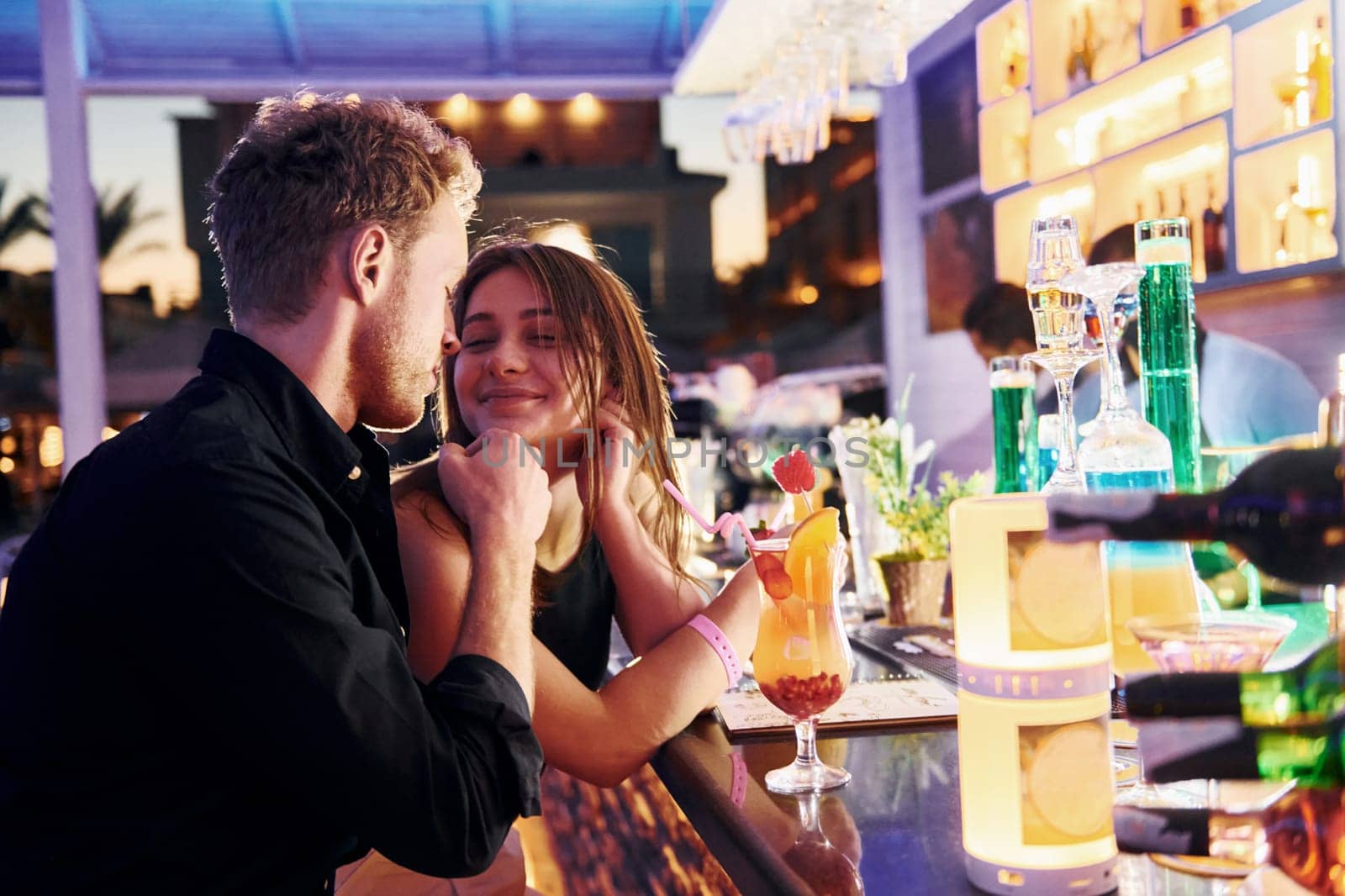 At the bar. Happy young couple is together on their vacation.