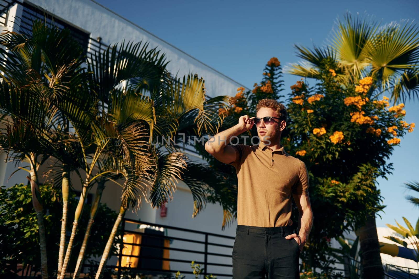 Beautiful nature. Young man is outdoors at sunny daytime. Concept of vacation.